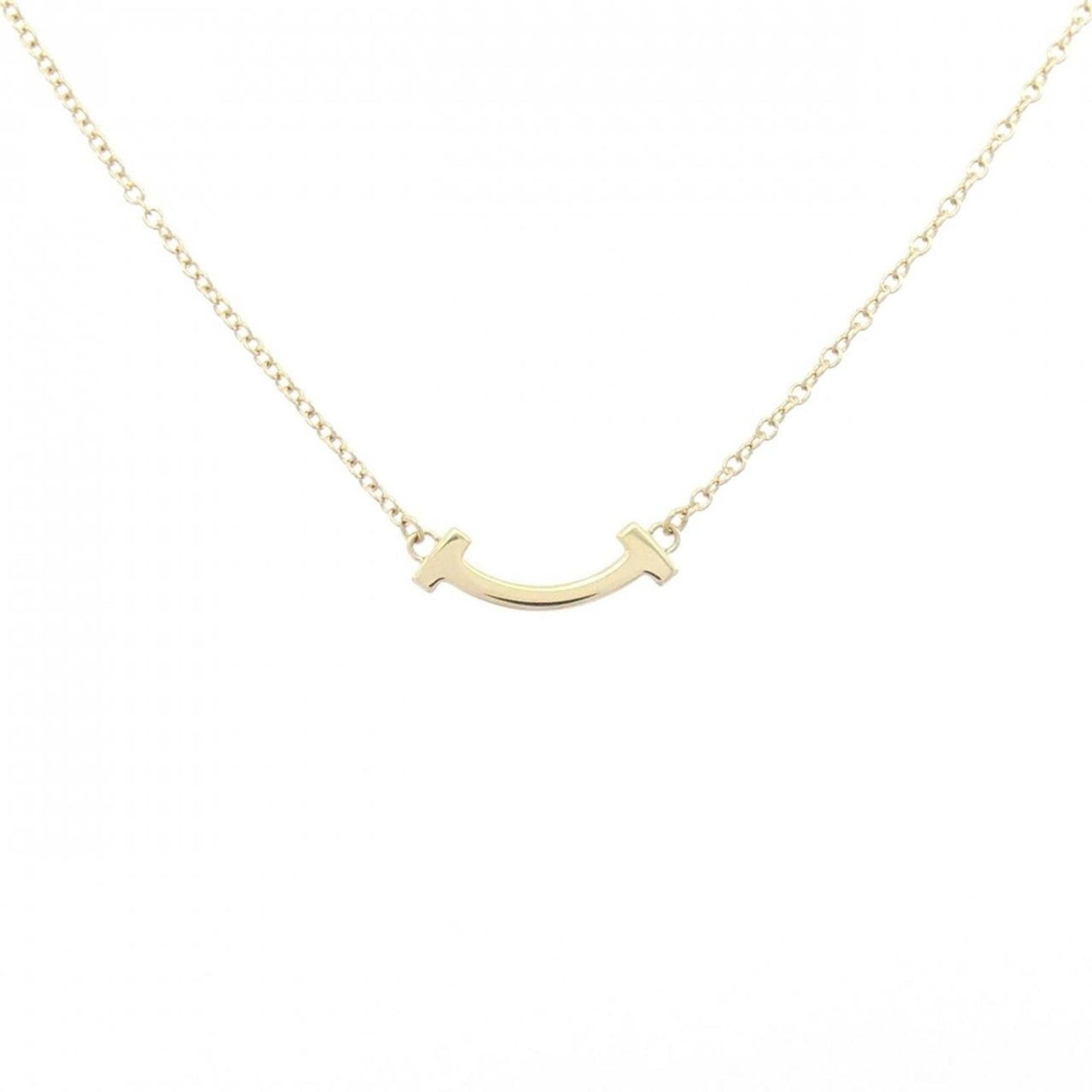 Tiffany T Smile Mini Necklace: Tiffany T Smile Mini Necklace Yellow gold (18K) pendant necklace featuring a Tiffany T Smile design, with a 3.6mm x 13.4mm pendant size and adjustable neck circumference of 41-46 cm. This used
