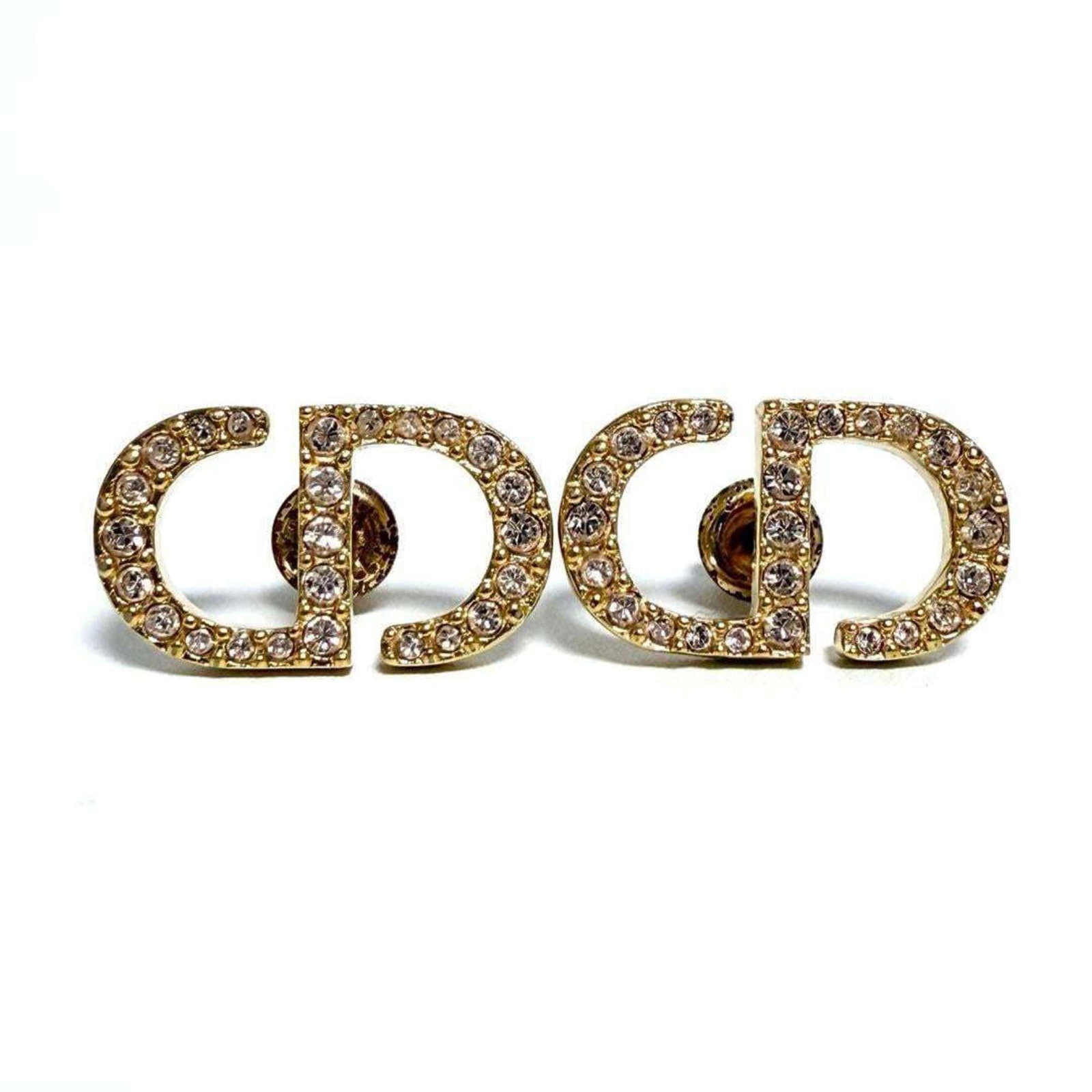 Christian Dior Stud Earrings Metal, Rhinestone: Christian Dior Stud Earrings Metal, Rhinestone Stud earrings from Christian Dior feature metal and rhinestone details in pink. The condition shows traces of usage with minor scratches and dirt,