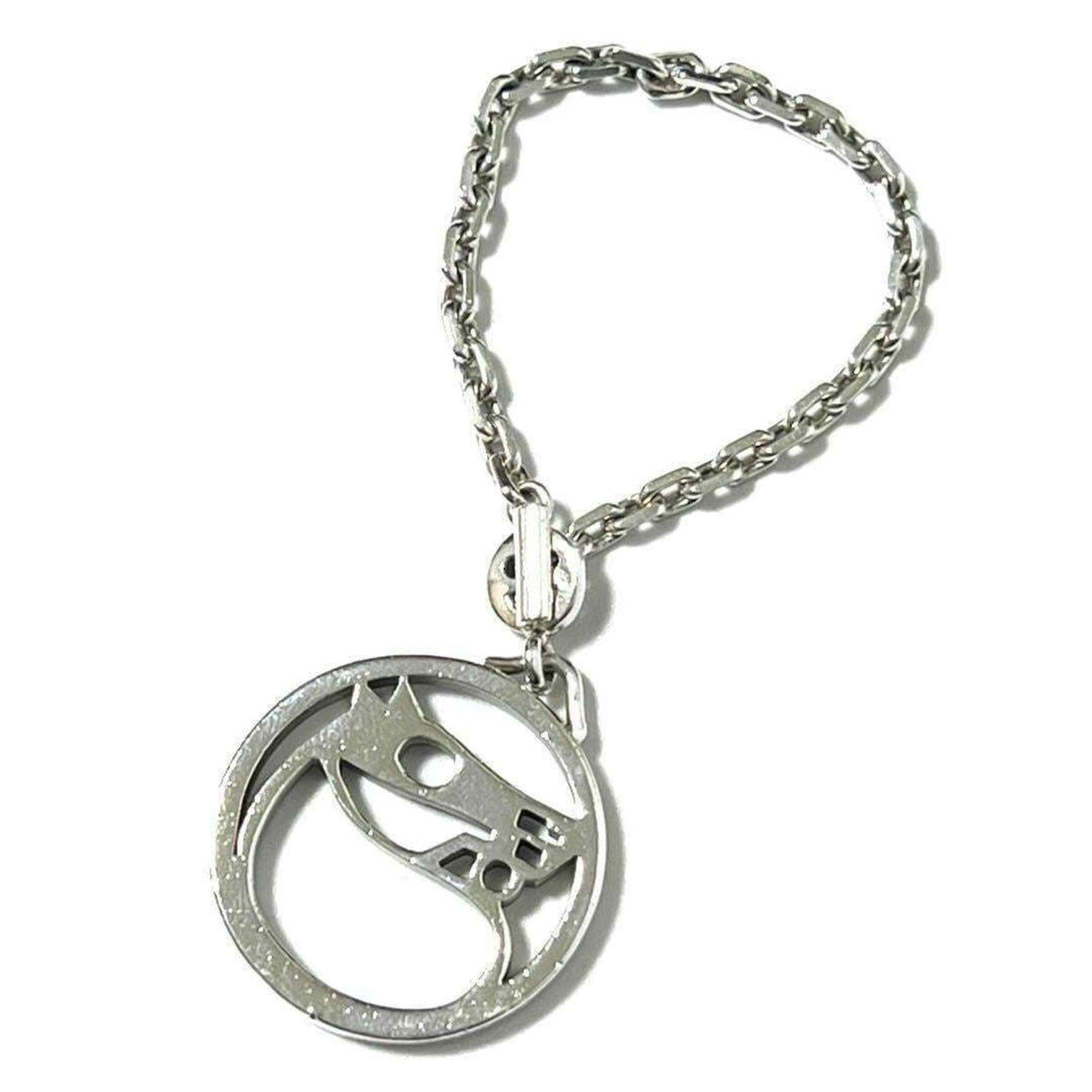 Hermes Handbag Charm Silver: Hermes Handbag Charm Silver This silver Hermes handbag charm boasts a sleek and sophisticated design, bearing a few subtle signs of wear. Despite its used condition, the charm remains in very good