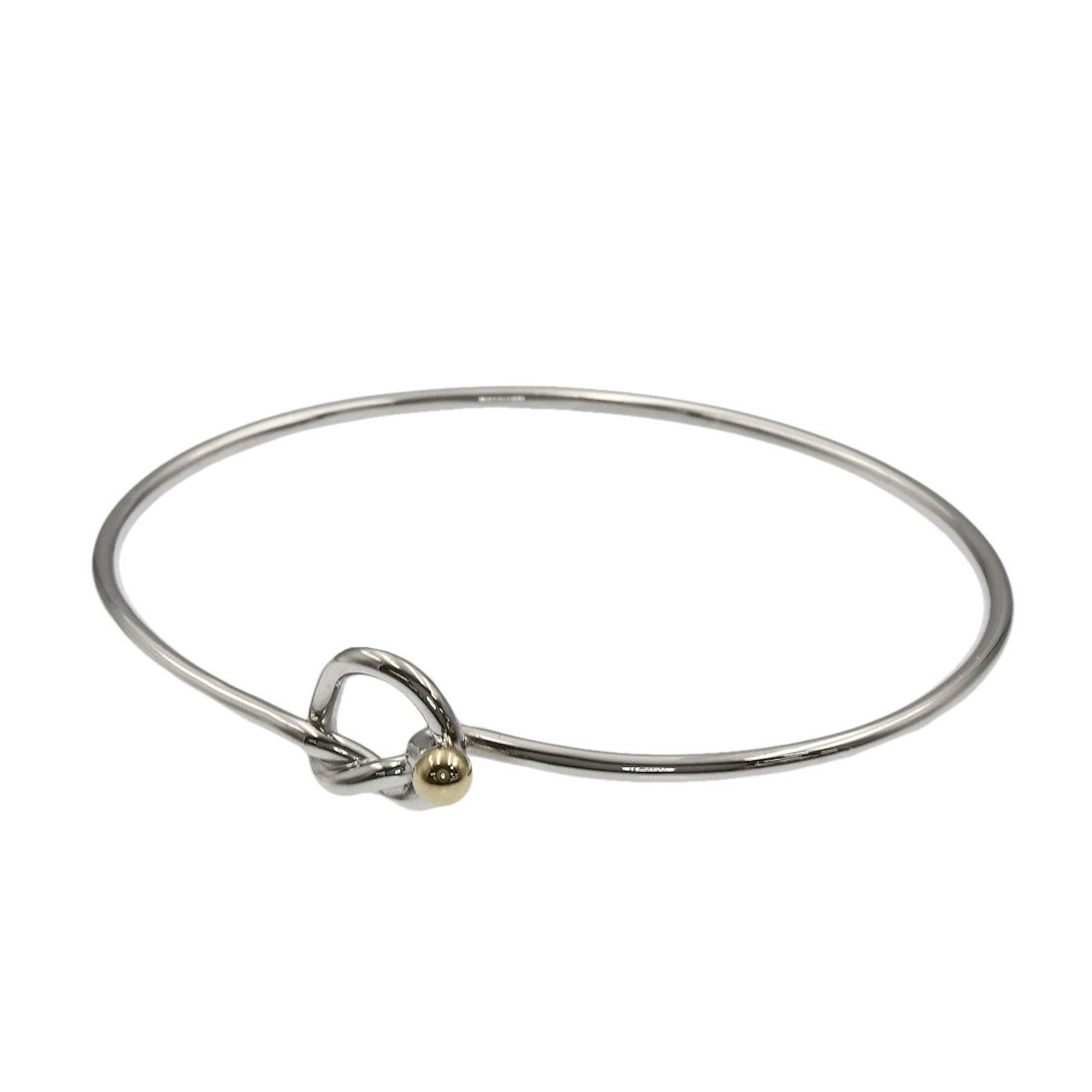 Tiffany Charm Bracelet Silver, Yellow Gold (18K): Tiffany Charm Bracelet Silver, Yellow Gold (18K) Silver and yellow gold (18K) charm bracelet from Tiffany. This used charm bracelet features some scratches and dirt, but remains in very good condition