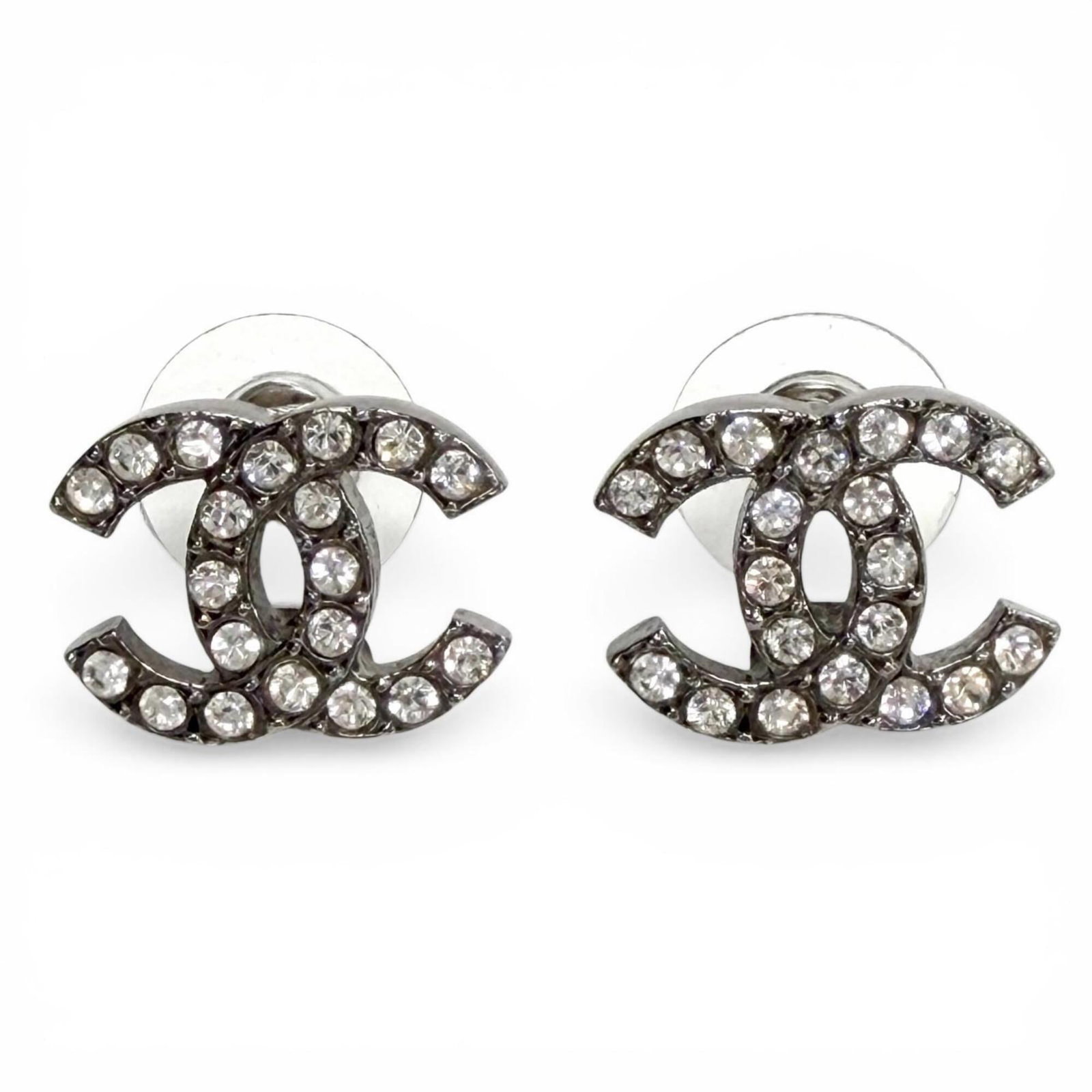 Chanel Stud Earrings Metal: Chanel Stud Earrings Metal Chanel's iconic stud earrings showcase understated elegance with their sleek metal design and sparkling rhinestones. Made from high-quality metal, these earrings feature a c