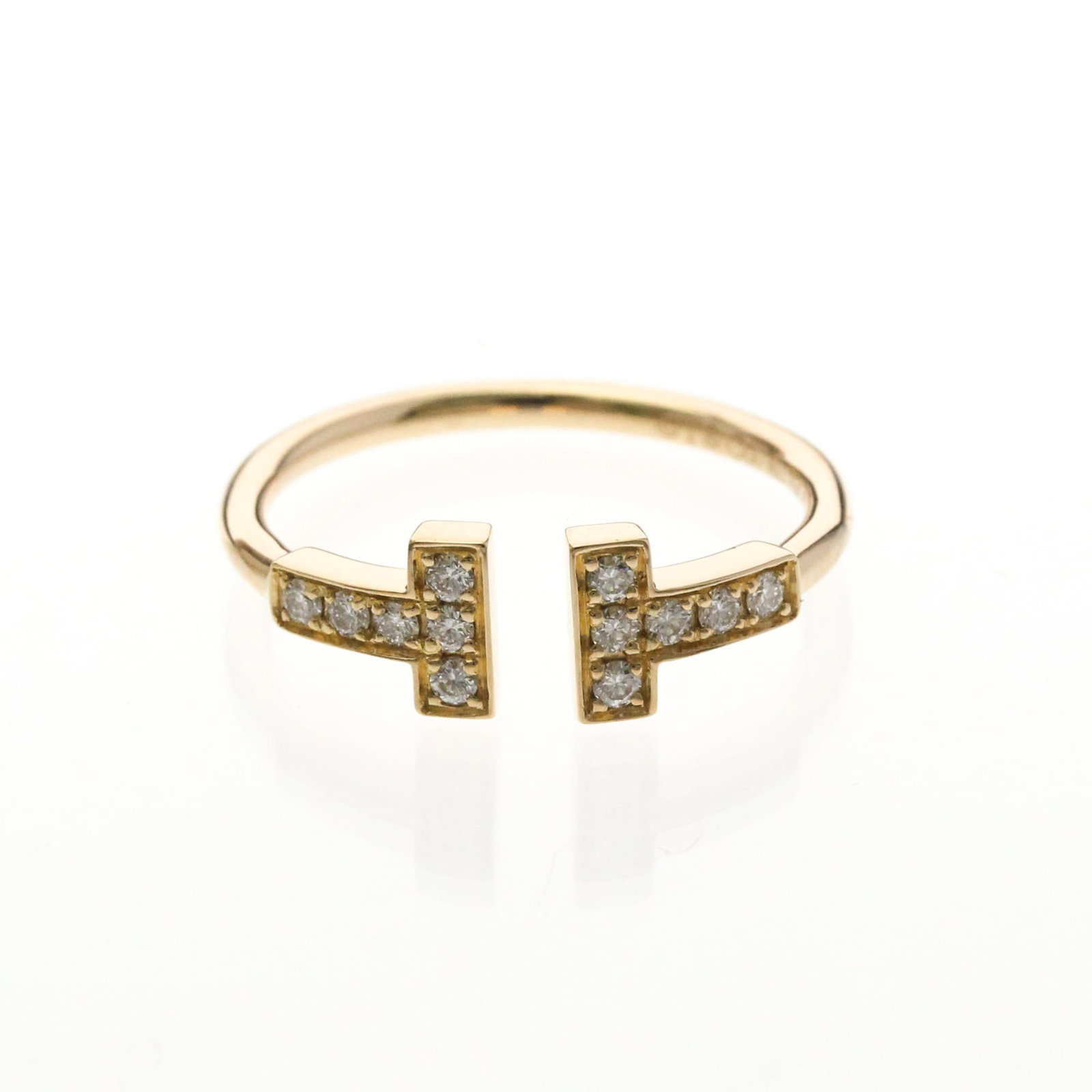 Tiffany Band Ring Pink Gold (18K): Tiffany Band Ring Pink Gold (18K) Pink Gold (18K) band ring from Tiffany Type features a delicate 1.6mm wide design with a diamond stone, available in size 5-5.5 and weighing 2.2g. This used item boas