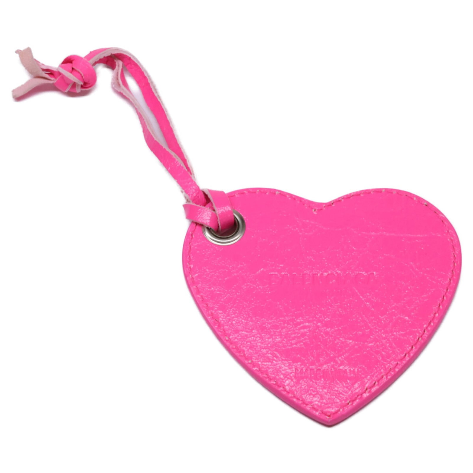 Balenciaga Handbag Charm: Balenciaga Handbag Charm This Balenciaga handbag charm boasts a vibrant pink hue and shows signs of being used, with a few scratches and dirt marks visible. Despite its worn appearance, the charm rema