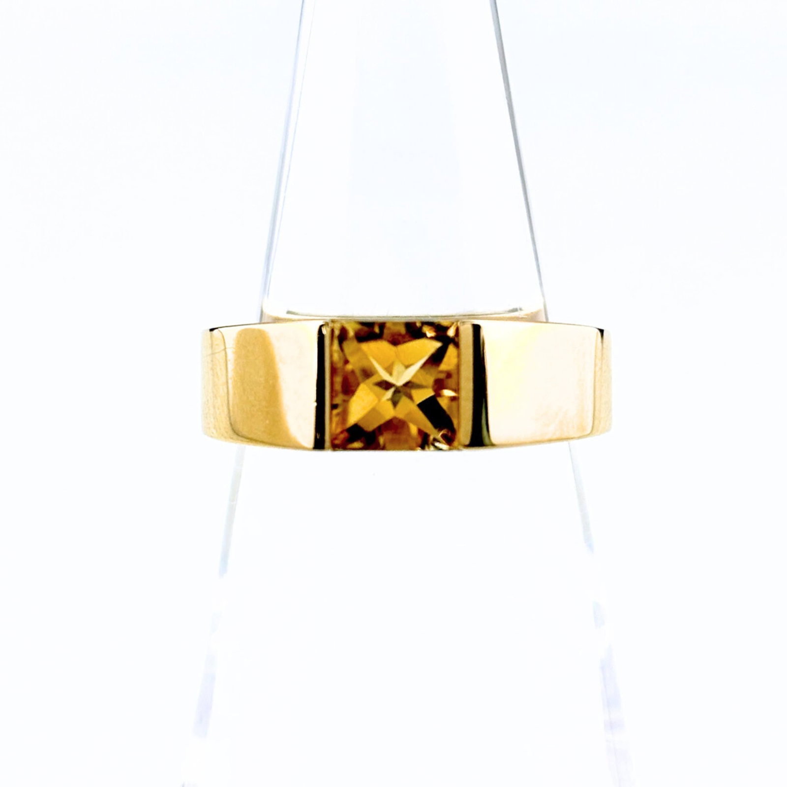 Cartier Band Ring: Cartier Band Ring Cartier Band Ring features a citrine stone and is made from high-quality materials. The ring has been worn and shows signs of use, with some scratches and dirt visible. Overall, its