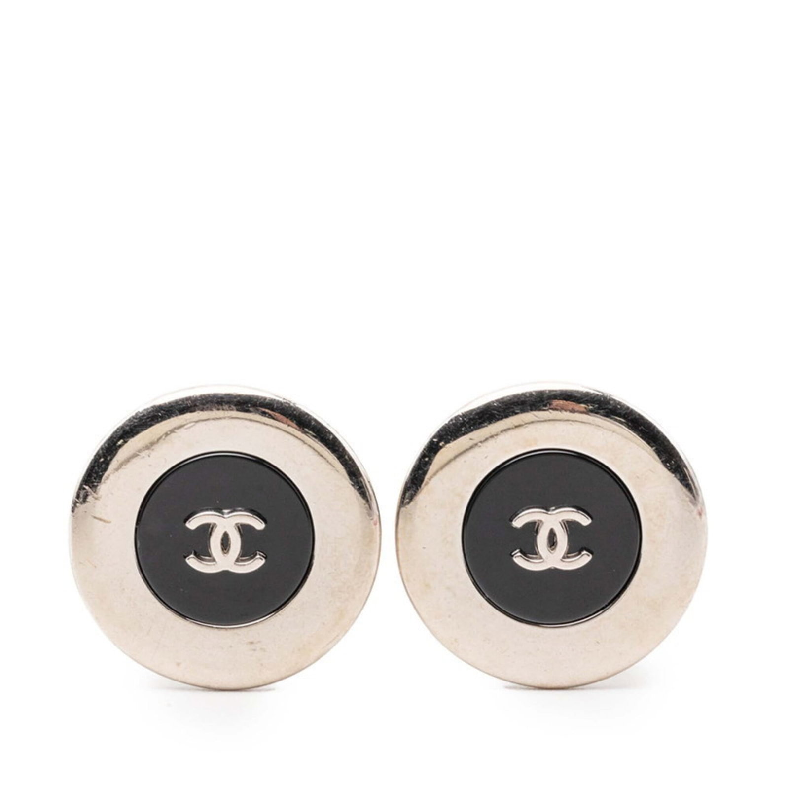 Chanel Clip Earrings Metal: Chanel Clip Earrings Metal Black metal clip earrings from Chanel, showing signs of use with minor scratches and dirt. The classic design remains intact despite its worn condition. A subtle touch of