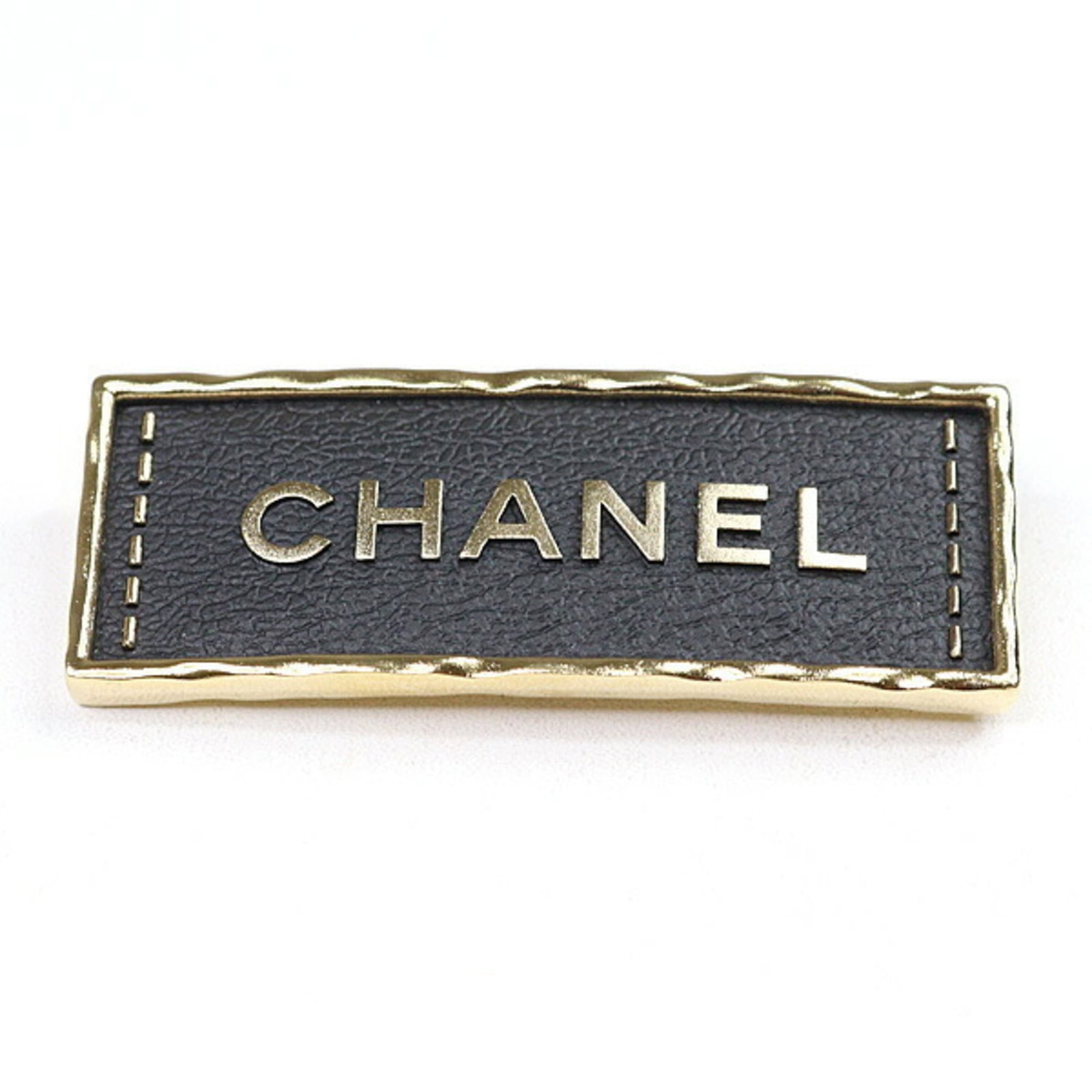 Chanel Brooch Leather, Metal: Chanel Brooch Leather, Metal This Chanel brooch features a striking combination of black leather and gold metal, showcasing a sleek and sophisticated design. With its compact size and substantial