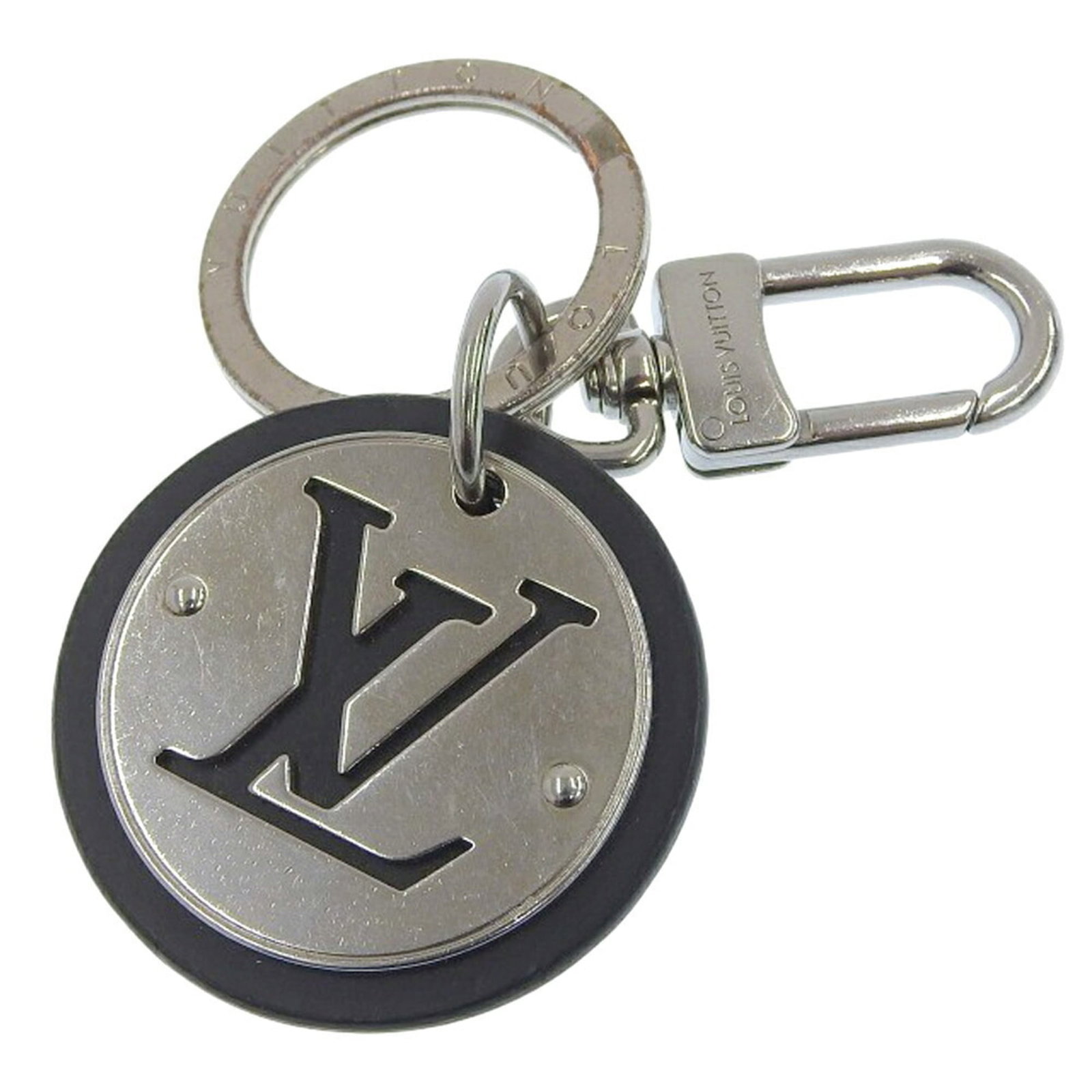 Louis Vuitton Handbag Charm Leather, Metal: Louis Vuitton Handbag Charm Leather, Metal This Louis Vuitton handbag charm features black leather and metal construction. It shows signs of usage with minor scratches and dirt, but remains in good co