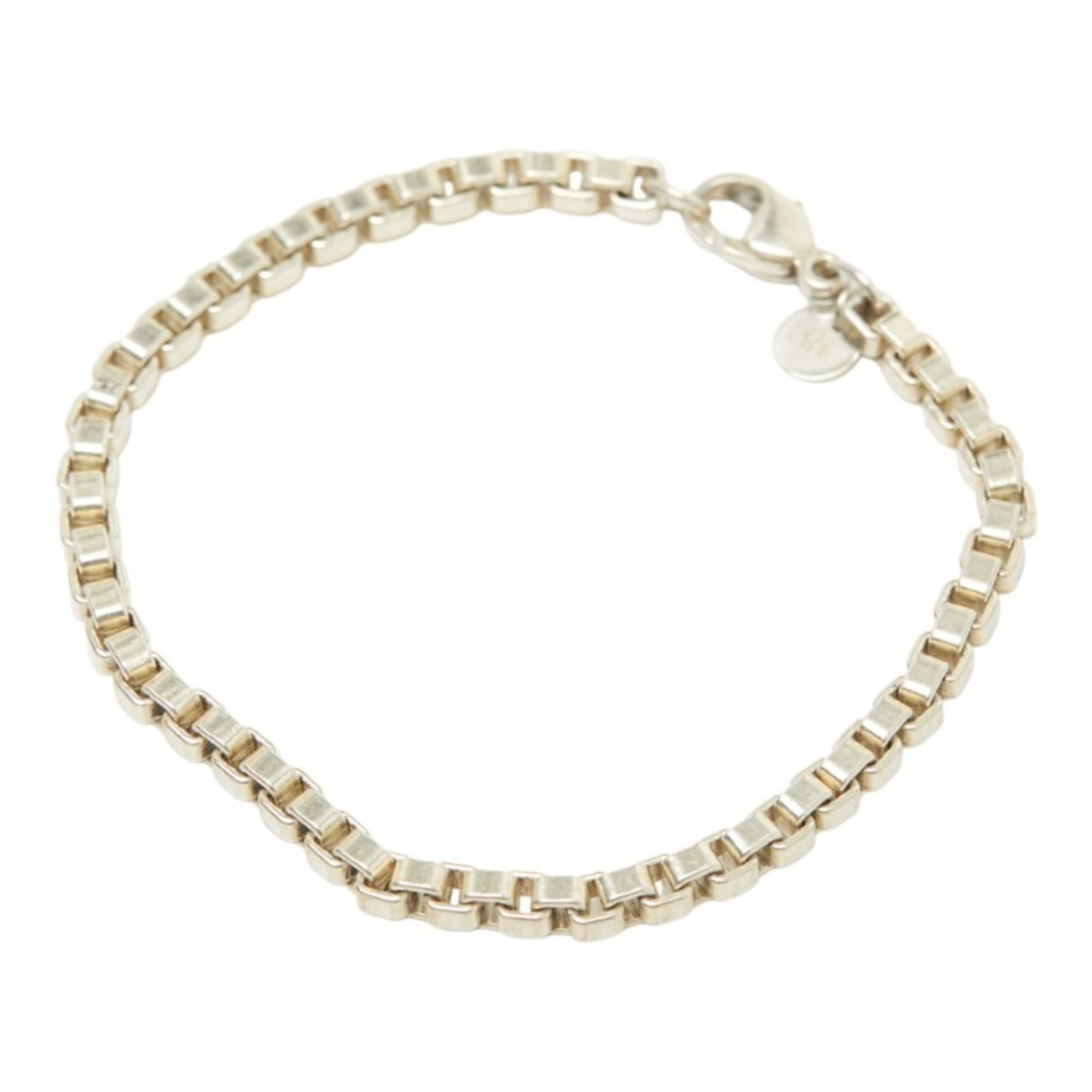 Tiffany Charm Bracelet Silver 925: Tiffany Charm Bracelet Silver 925 Silver 925 Tiffany Charm Bracelet with Traces of Usage. This used charm bracelet features silver 925 material and has a length of 18cm. It shows signs of previous