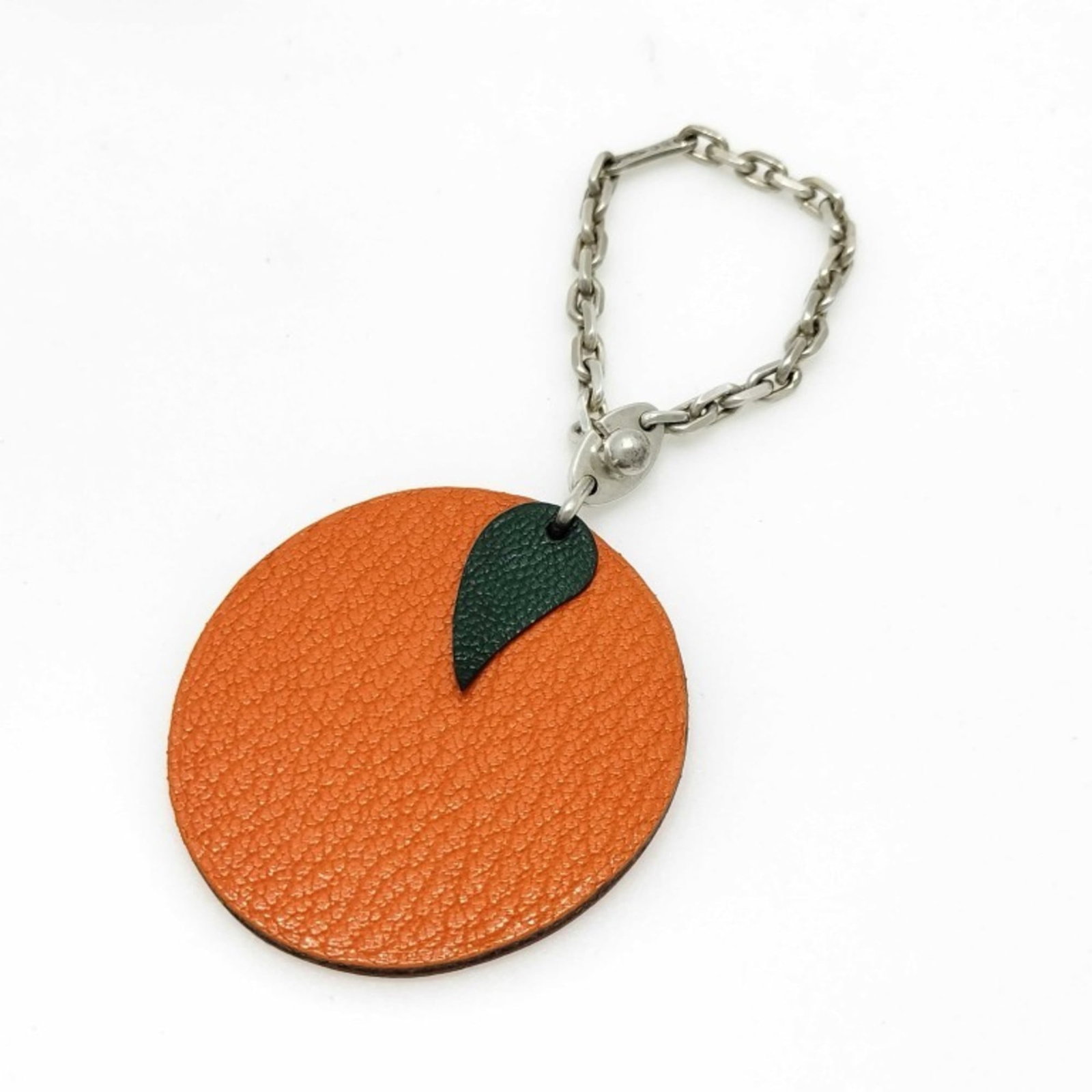 Hermes Handbag Charm Leather, Silver 925: Hermes Handbag Charm Leather, Silver 925 The Hermes Handbag Charm Leather, Silver 925 features a vibrant orange and silver design, showcasing exceptional craftsmanship. Made from high-quality leather 