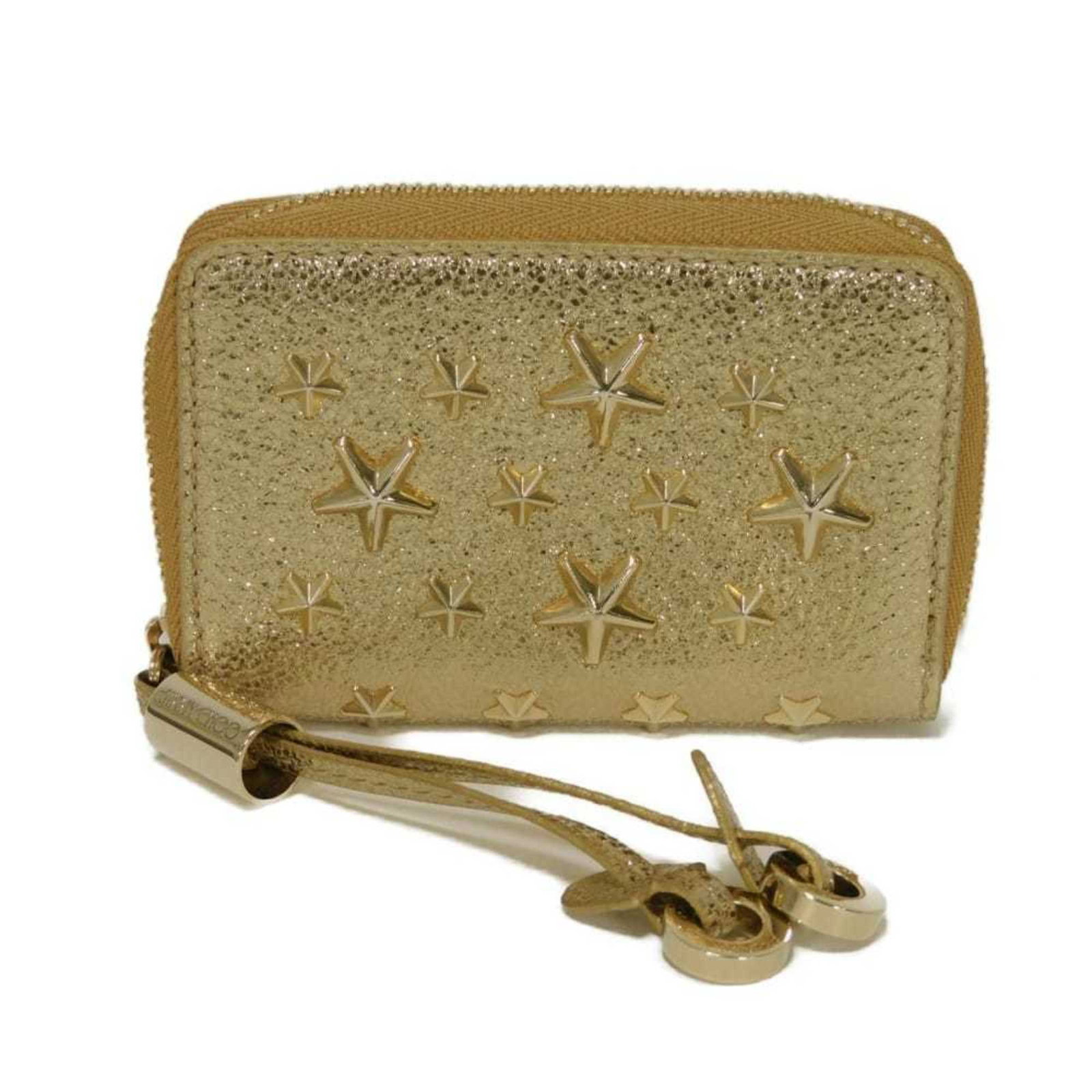 Jimmy Choo Coin Purse/Coin Case Leather: Jimmy Choo Coin Purse/Coin Case Leather This luxurious leather coin purse from Jimmy Choo boasts a sleek metallic gold finish and premium calfskin material. Its compact size makes it perfect for stori