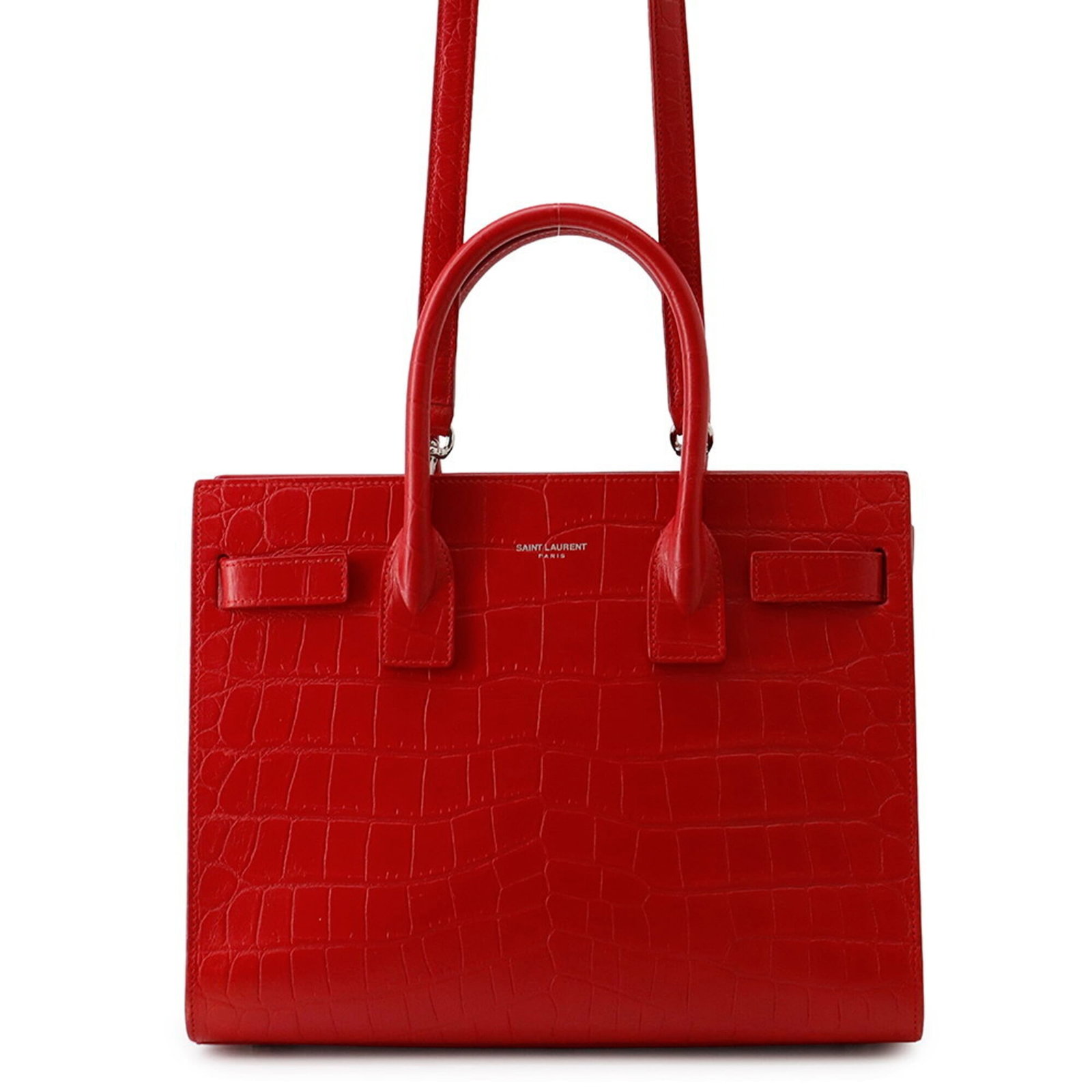 Yves Saint Laurent Handbag Leather: Yves Saint Laurent Handbag Leather The Yves Saint Laurent handbag boasts an embossed leather exterior in rich red, adorned with sleek silver hardware. Measuring 20cm x 26cm x 11cm, this stylish bag fe