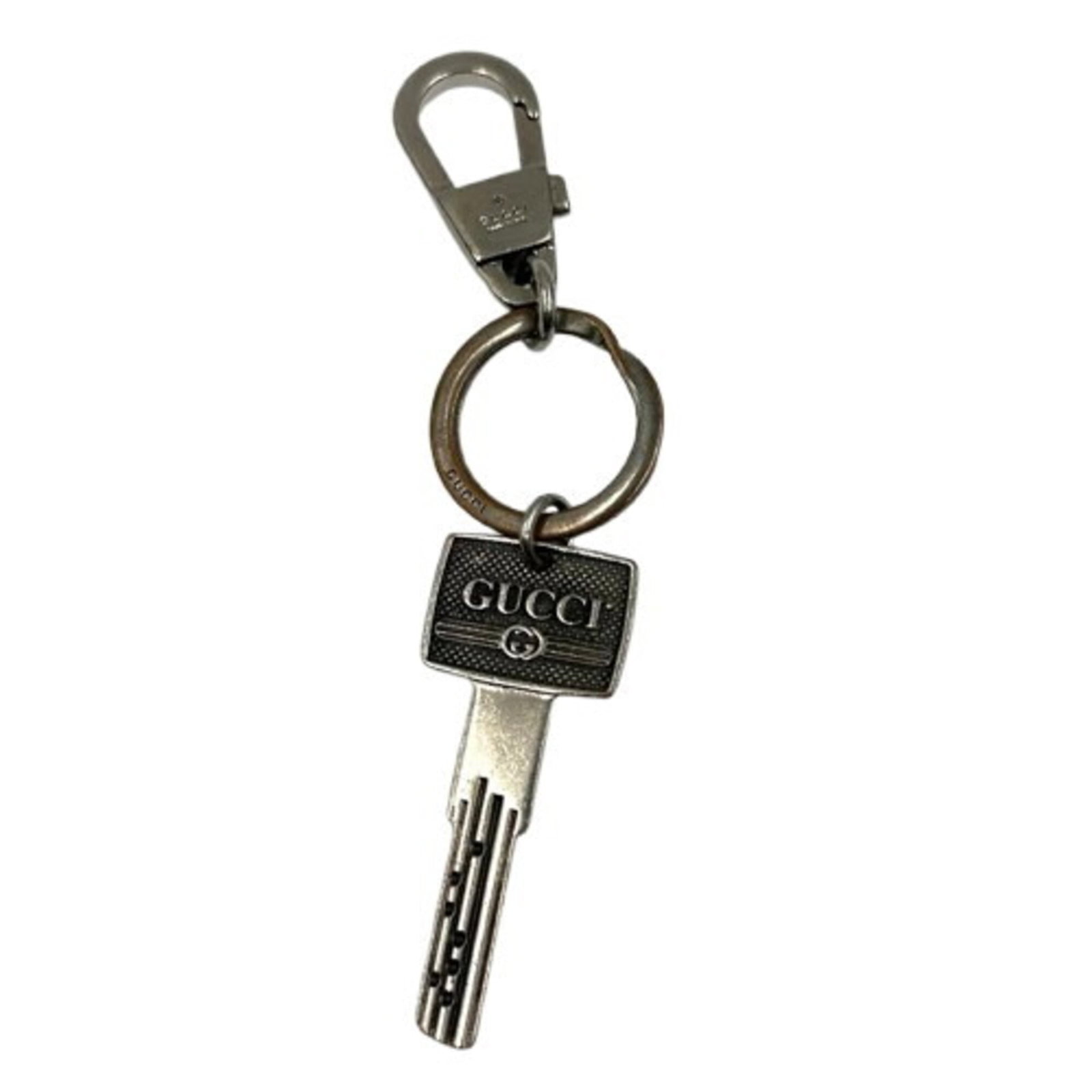 Gucci Keyring Metal: Gucci Keyring Metal The Gucci Keyring Metal boasts a sleek silver finish and a compact charm size of 6.5cm x 2.8cm, making it a stylish accessory for everyday carry. With its metal material and subtle