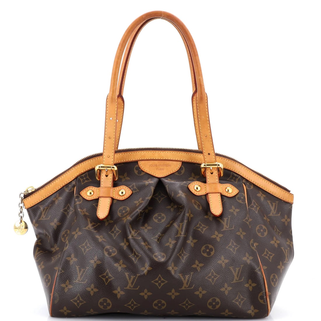 Canvas monogram handbag bag Tivoli Louis Vuitton: Canvas monogram handbag bag Tivoli Louis Vuitton Exterior features a classic Louis Vuitton canvas monogram pattern in brown, with exposed piping on base corners and heavy corner wear. The Tivoli handb