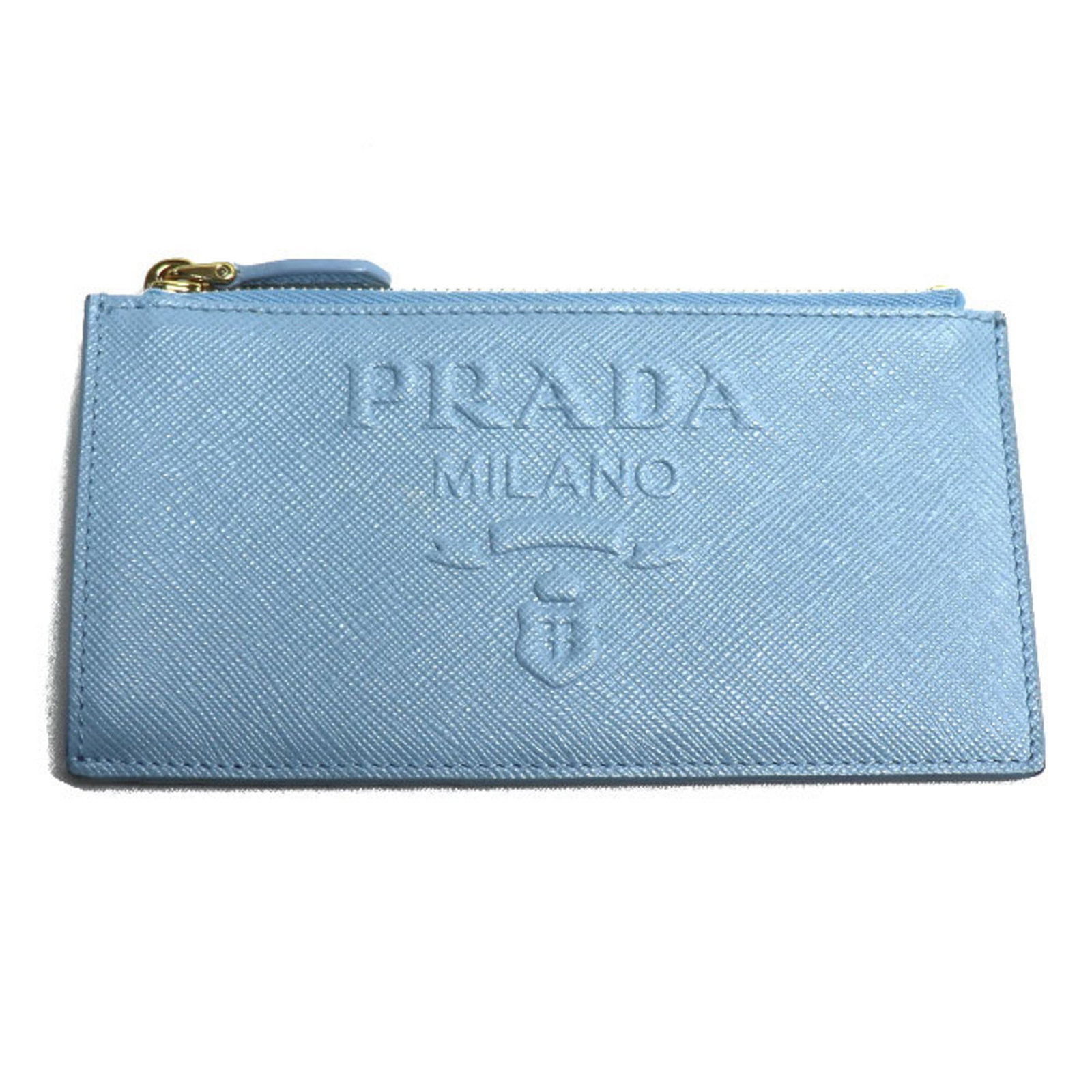Prada Coin Purse/Coin Case Leather: Prada Coin Purse/Coin Case Leather This Prada coin purse/case leather features a light blue color and measures 8cm x 15.5cm in size. With some minor scratches and dirt, this used item remains in very 