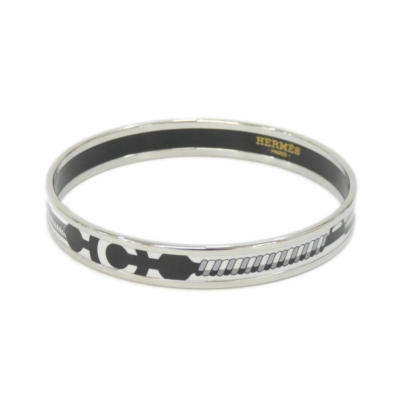 Hermes Bangle: Hermes Bangle A sleek and sophisticated Herm?s bangle in black, silver, or white, with a length of 19.5cm / 7.67''. This used item boasts a few traces of usage, some scratches and dirt visible, but re