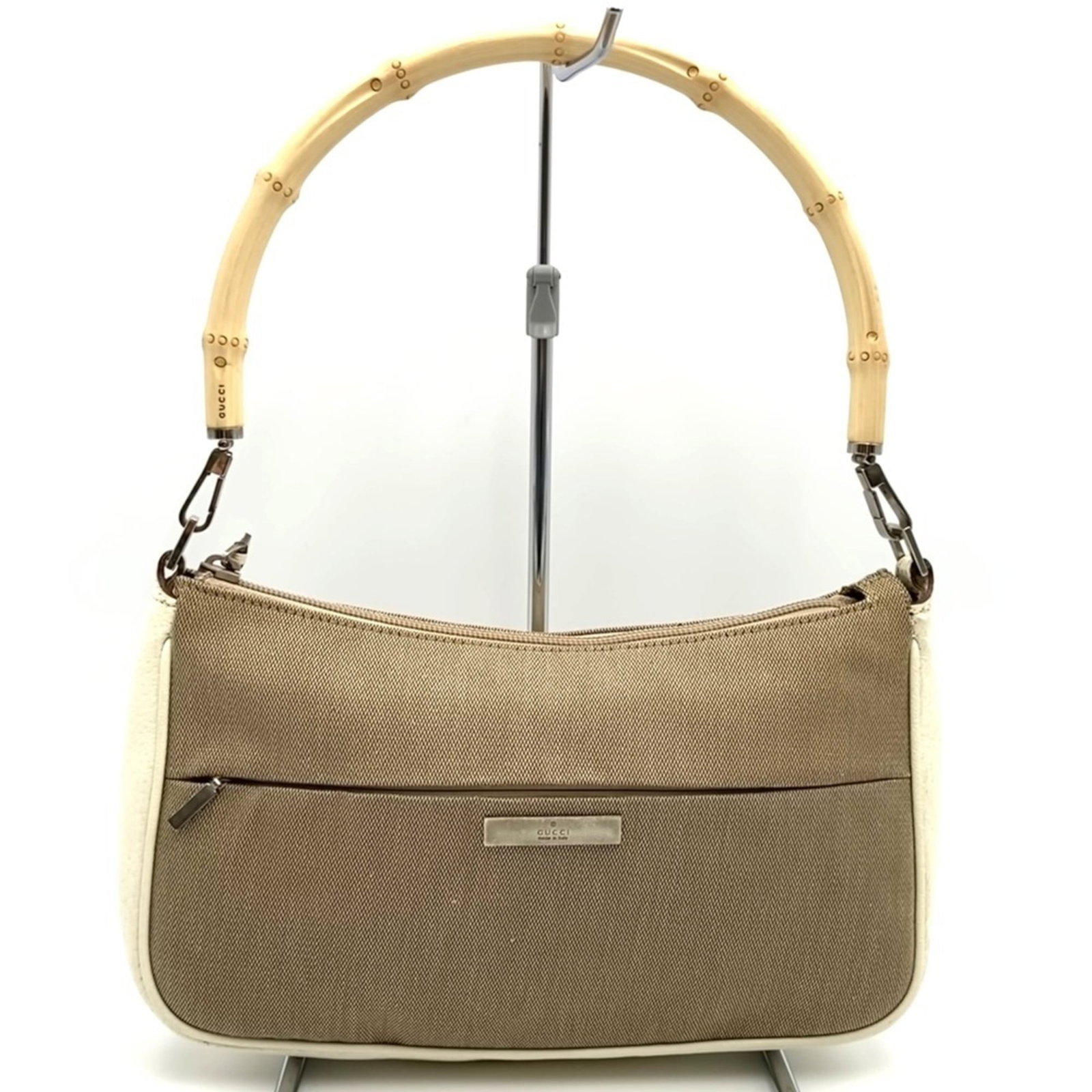 Gucci Handbag Canvas Leather: Gucci Handbag Canvas Leather Canvas and leather combine in this Gucci handbag, available in beige. The bag measures 15cm x 26cm x 5cm and shows signs of usage, including scratches and dirt. Its