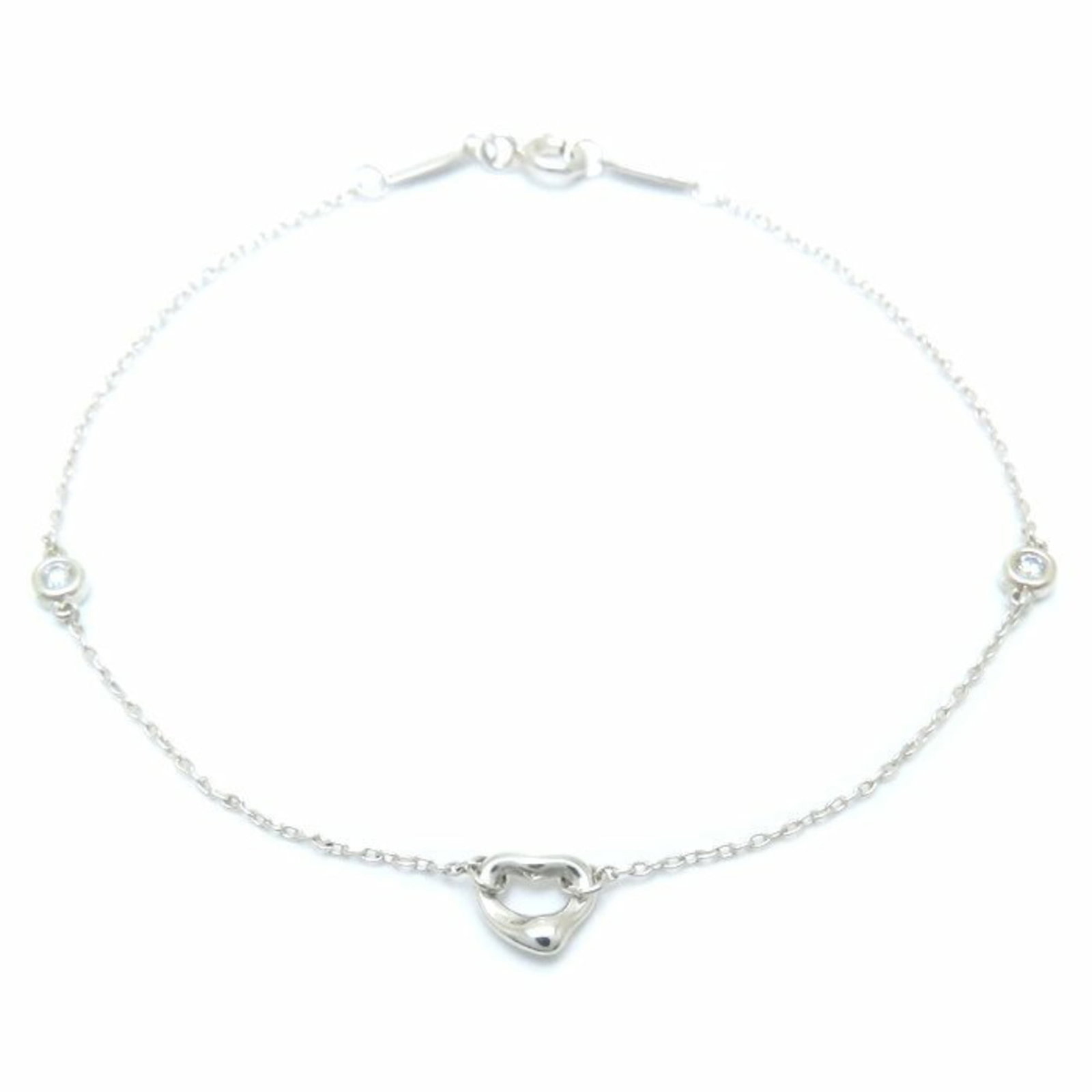 Tiffany Charm Bracelet: Tiffany Charm Bracelet This Tiffany charm bracelet features a silver chain and a diamond stone, set in an elegant design. The intricate details of the metalwork are still visible despite some minor sc