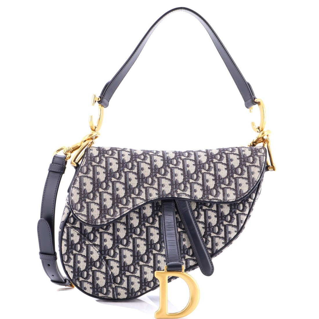 Dior Saddle Bag Canvas Strap: Dior Saddle Bag Canvas Strap The Dior Saddle Bag Canvas Strap features a striking blue canvas exterior with oblique design and gold hardware. Measuring 8" in height, 9.5" in width, and 3" in depth,