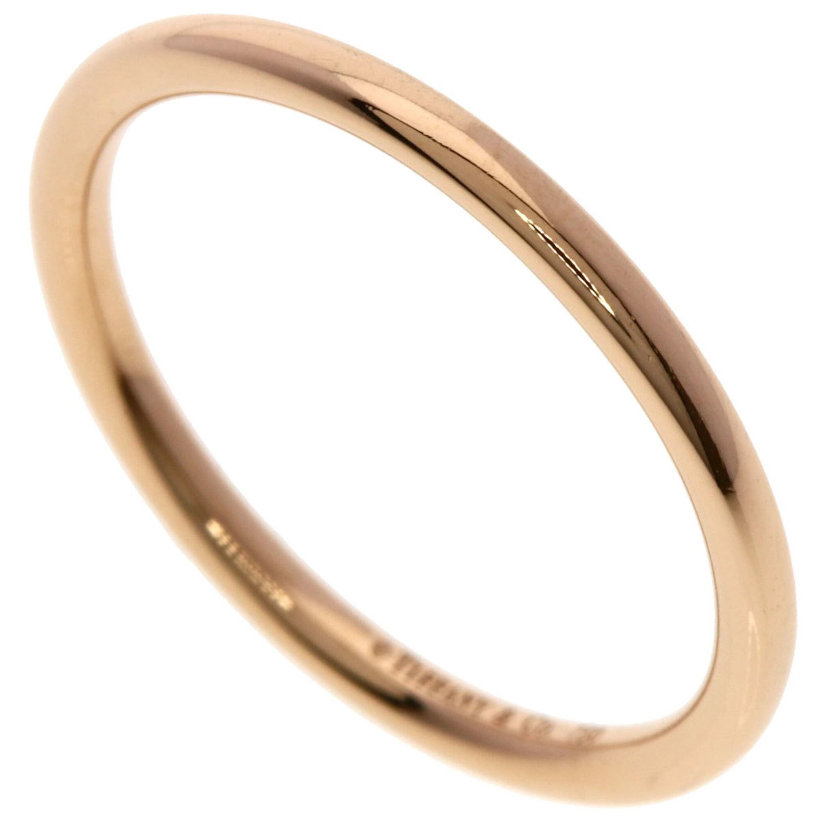 Tiffany Band Ring Pink Gold (18K): Tiffany Band Ring Pink Gold (18K) Pink Gold (18K) band ring from Tiffany, featuring a delicate design in this luxurious metal. The ring shows some minor signs of wear, with a few scratches and dirt ma