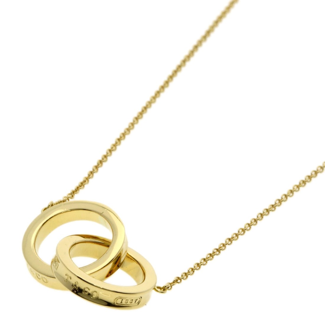 K18 Yellow Gold Interlocking Necklace Tiffany&Co.: K18 Yellow Gold Interlocking Necklace Tiffany&Co. K18 Yellow Gold Interlocking Necklace from Tiffany&Co. boasts a sleek design with no main stone, making it a stylish choice for those who appreciate u
