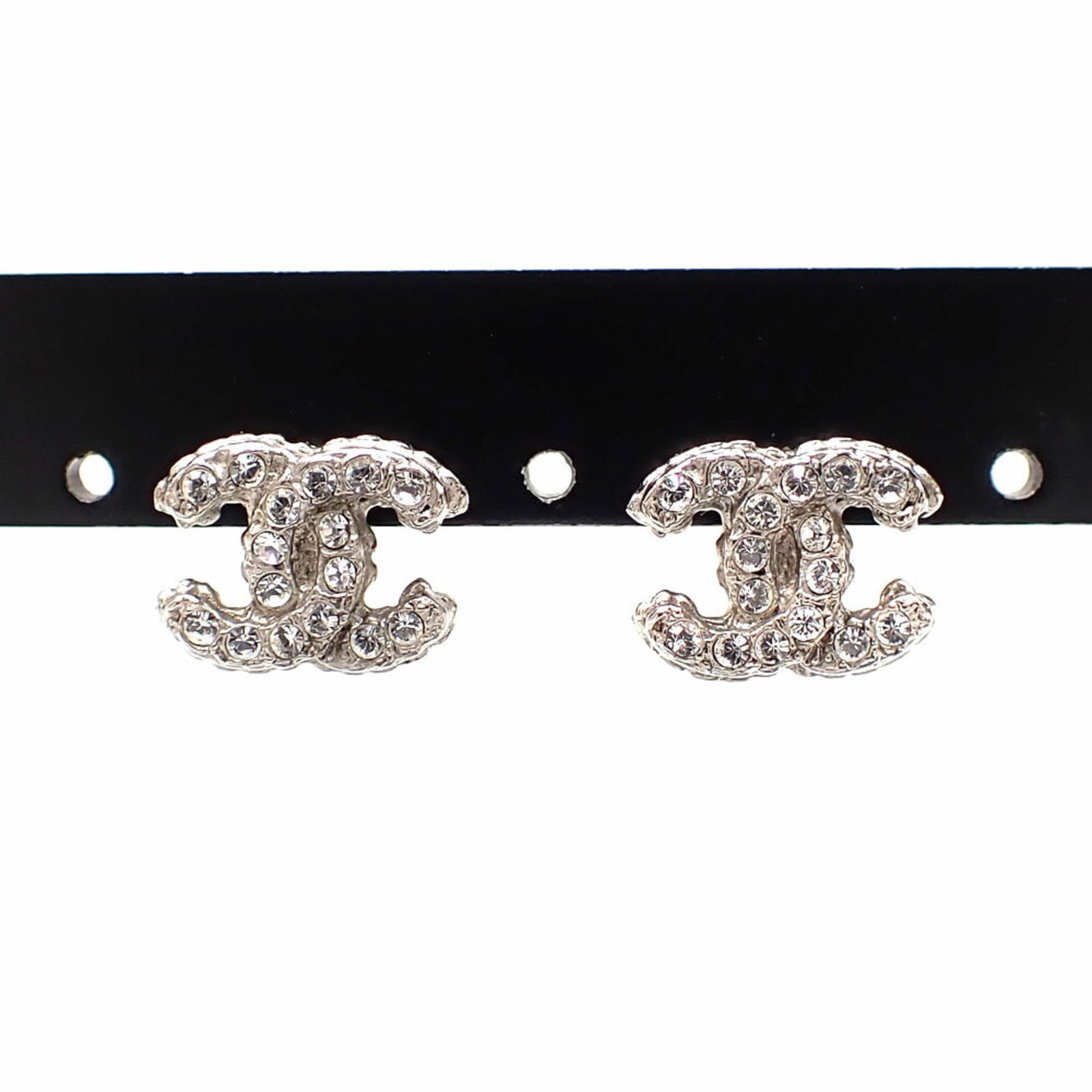 Chanel Stud Earrings Metal: Chanel Stud Earrings Metal Used Chanel stud earrings made of metal with rhinestone stones, measuring 9.00mm x 12.00mm x 12.00mm in size, bearing traces of usage and minor scratches. The earrings are