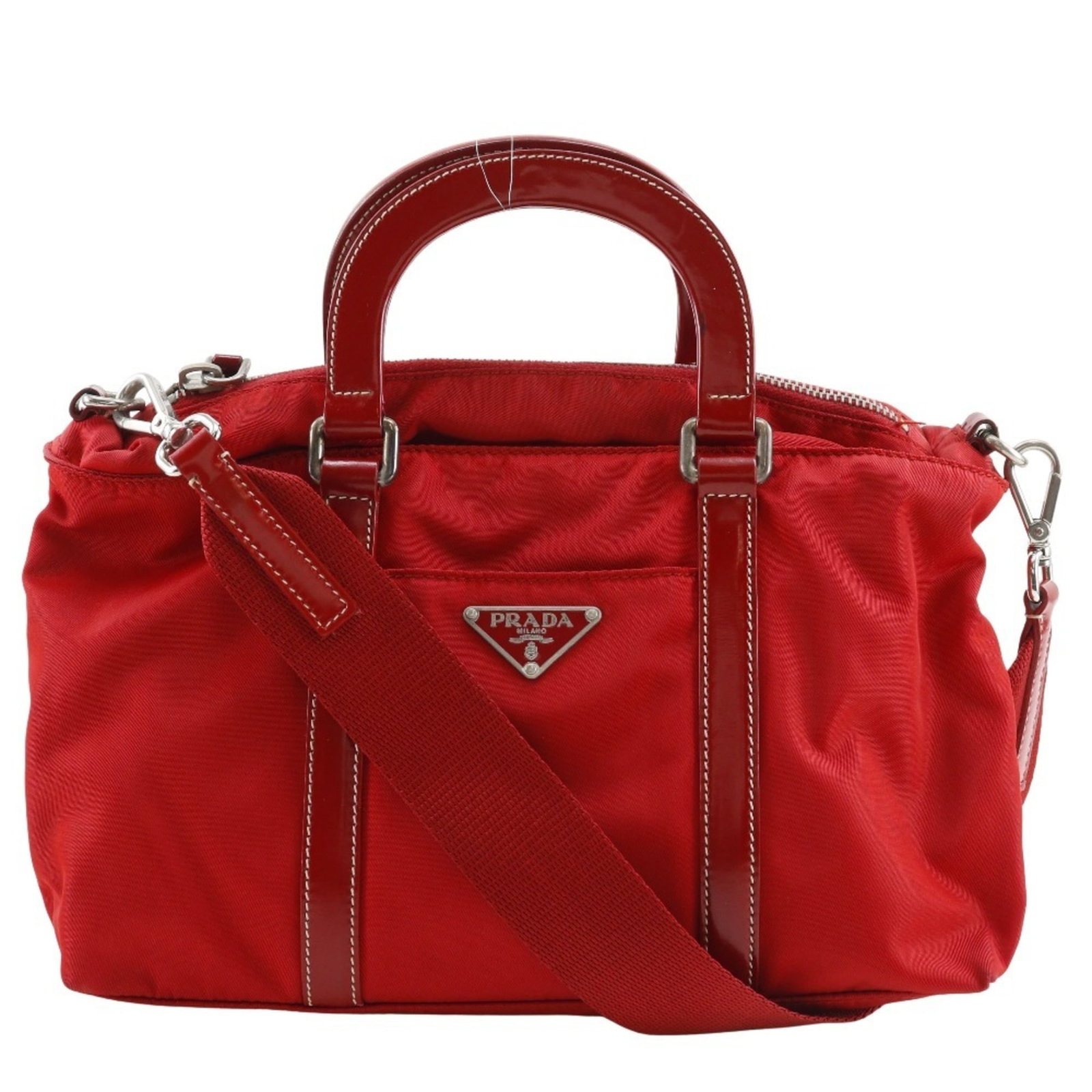 Prada Handbag Nylon: Prada Handbag Nylon This vibrant red Prada nylon handbag boasts its iconic design with a durable and versatile material. Measuring 16cm x 26cm x 7cm, it's a compact yet stylish accessory perfect for e