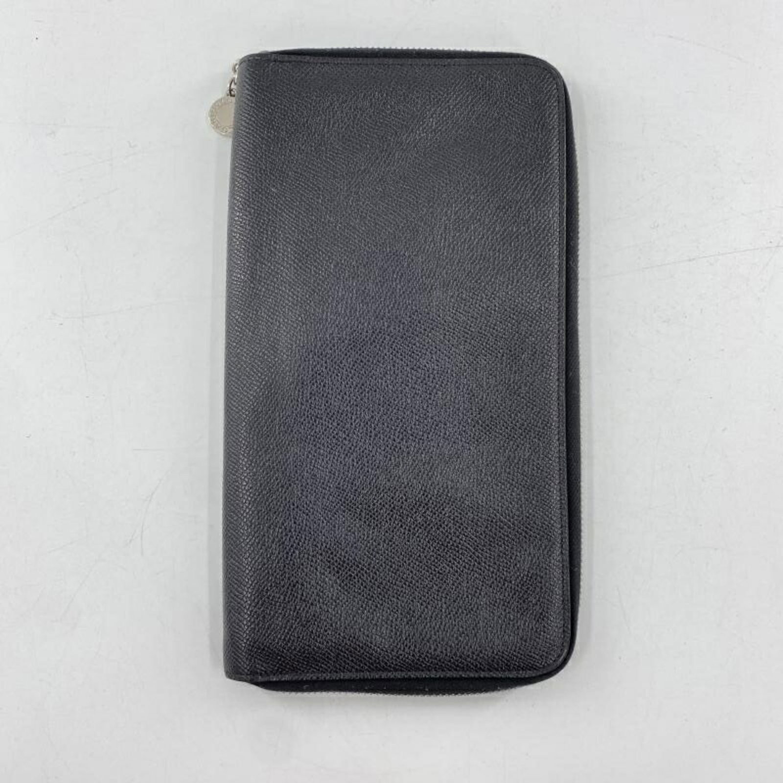 Bvlgari Long Wallet (Bi-Fold) Leather: Bvlgari Long Wallet (Bi-Fold) Leather Bvlgari's iconic long wallet features sleek black leather and a classic bi-fold design. With its durable construction and timeless style, this versatile accessory