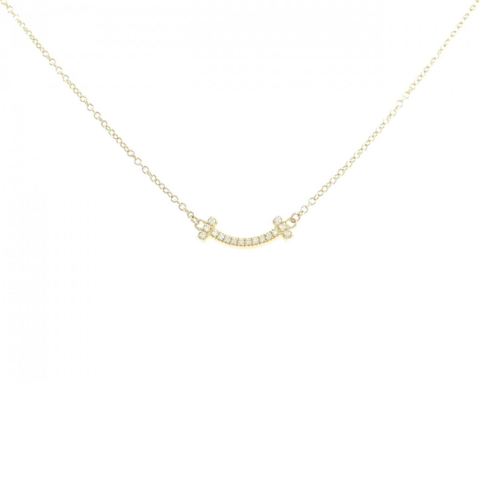 Tiffany T Smile Mini Necklace: Tiffany T Smile Mini Necklace Yellow Gold Tiffany Necklace with Pendant. This used necklace features a pendant with a 3.7mm x 13.3mm size and is made of yellow gold material. The necklace has a neck