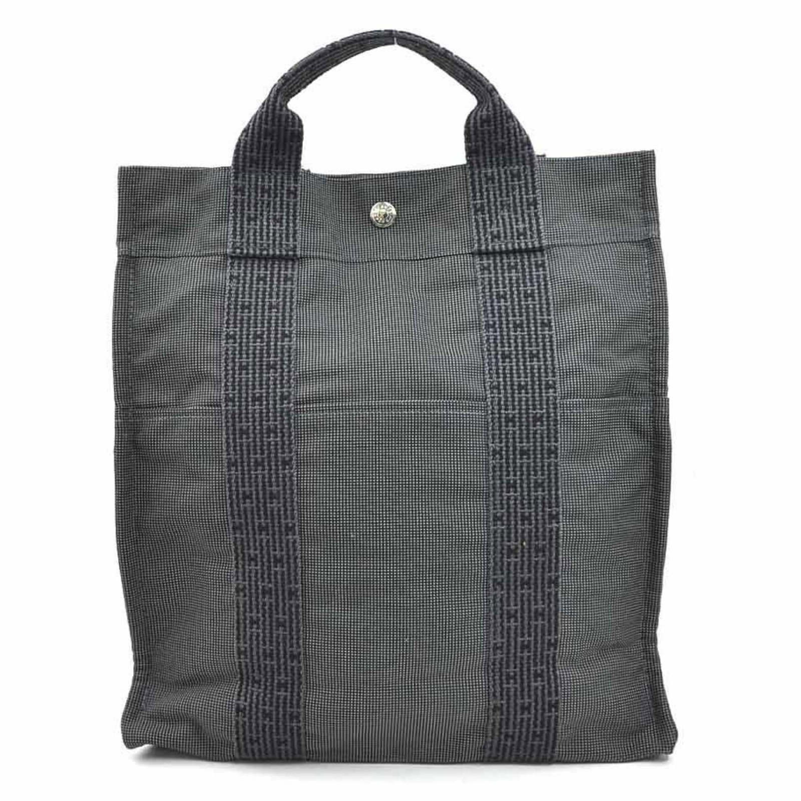Hermes Backpack Canvas: Hermes Backpack Canvas Dark Gray Canvas Backpack from Hermes with Silver Hardware. This used backpack features traces of usage and minor scratches/dirt, showcasing its worn-in character. With dimensio