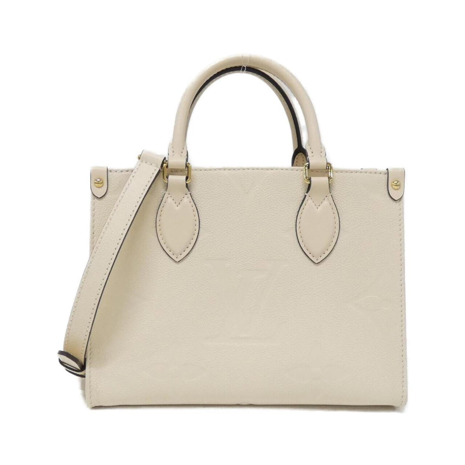 Louis Vuitton Handbag Leather: Louis Vuitton Handbag Leather Cream-colored Louis Vuitton handbag made from high-quality calf leather, featuring gold hardware and a classic design. The bag has been used and shows some signs of wear,