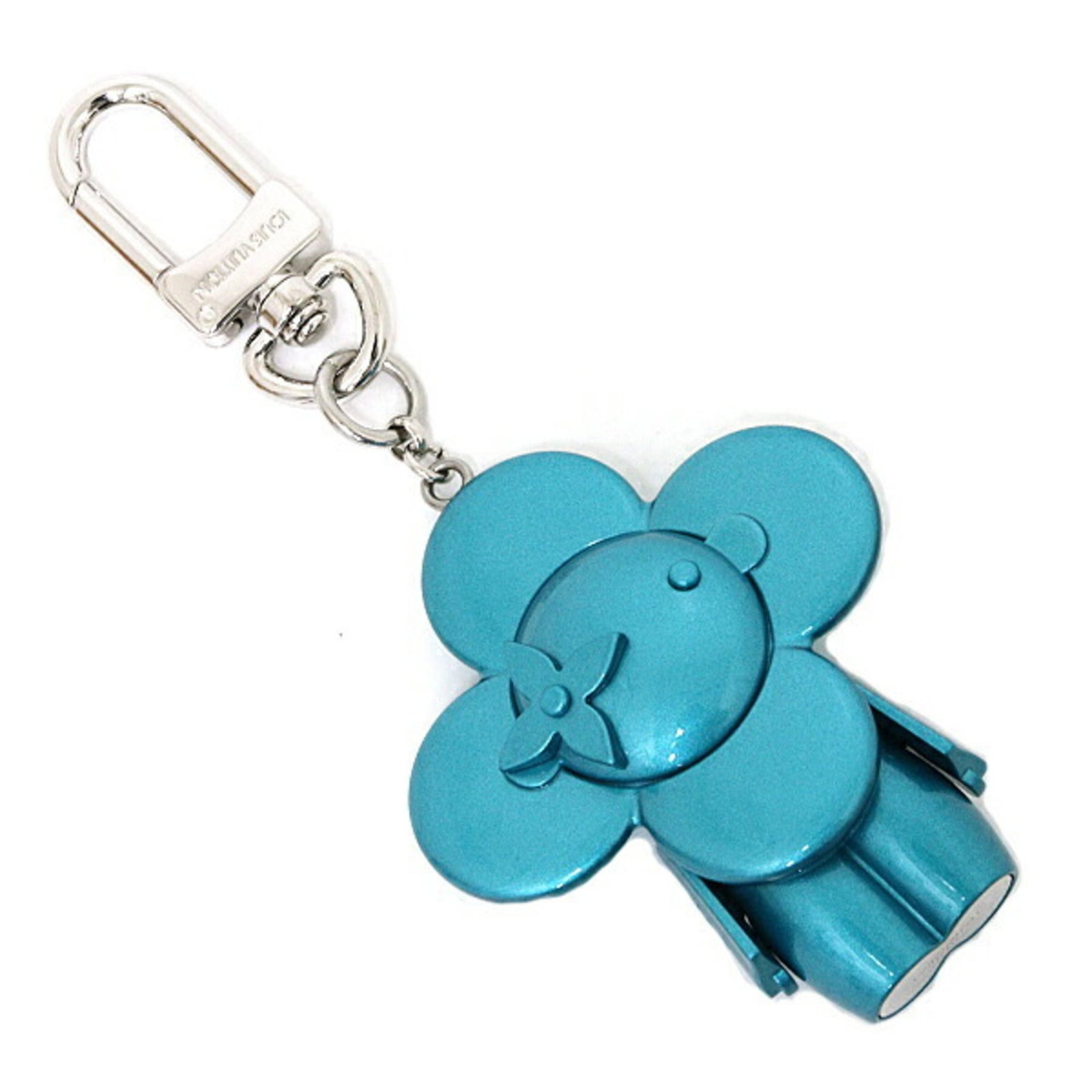 Louis Vuitton Keyring Metal: Louis Vuitton Keyring Metal Turquoise metal charm from Louis Vuitton adds a touch of elegance to your keys. This keyring features a unique turquoise hue and measures 7cm x 5.7cm in size. In very good 