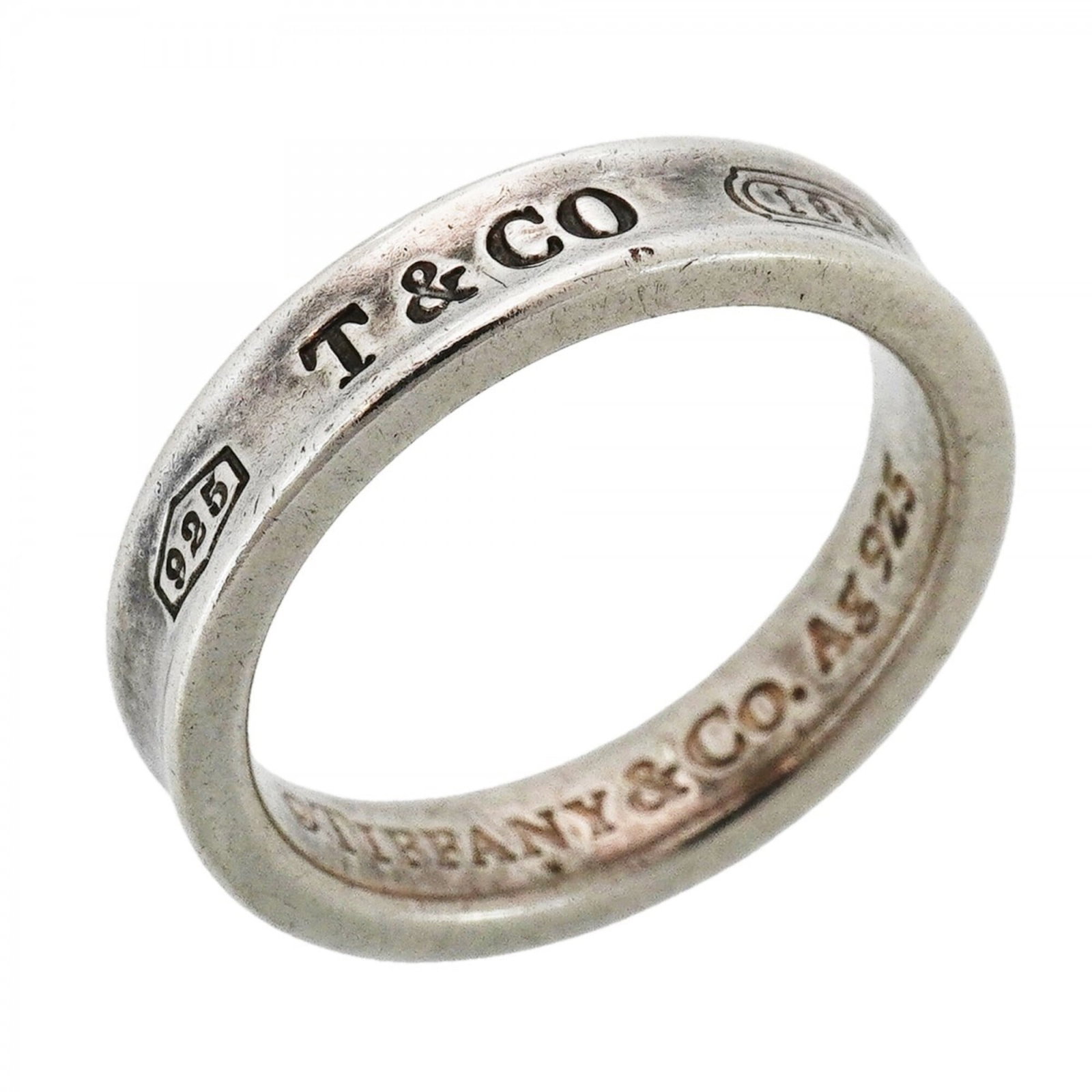 Tiffany Band Ring Silver 925: Tiffany Band Ring Silver 925 Silver 925 band ring from Tiffany features a classic design. The used condition shows traces of usage and minor scratches, with some dirt visible. Overall, this silver ban