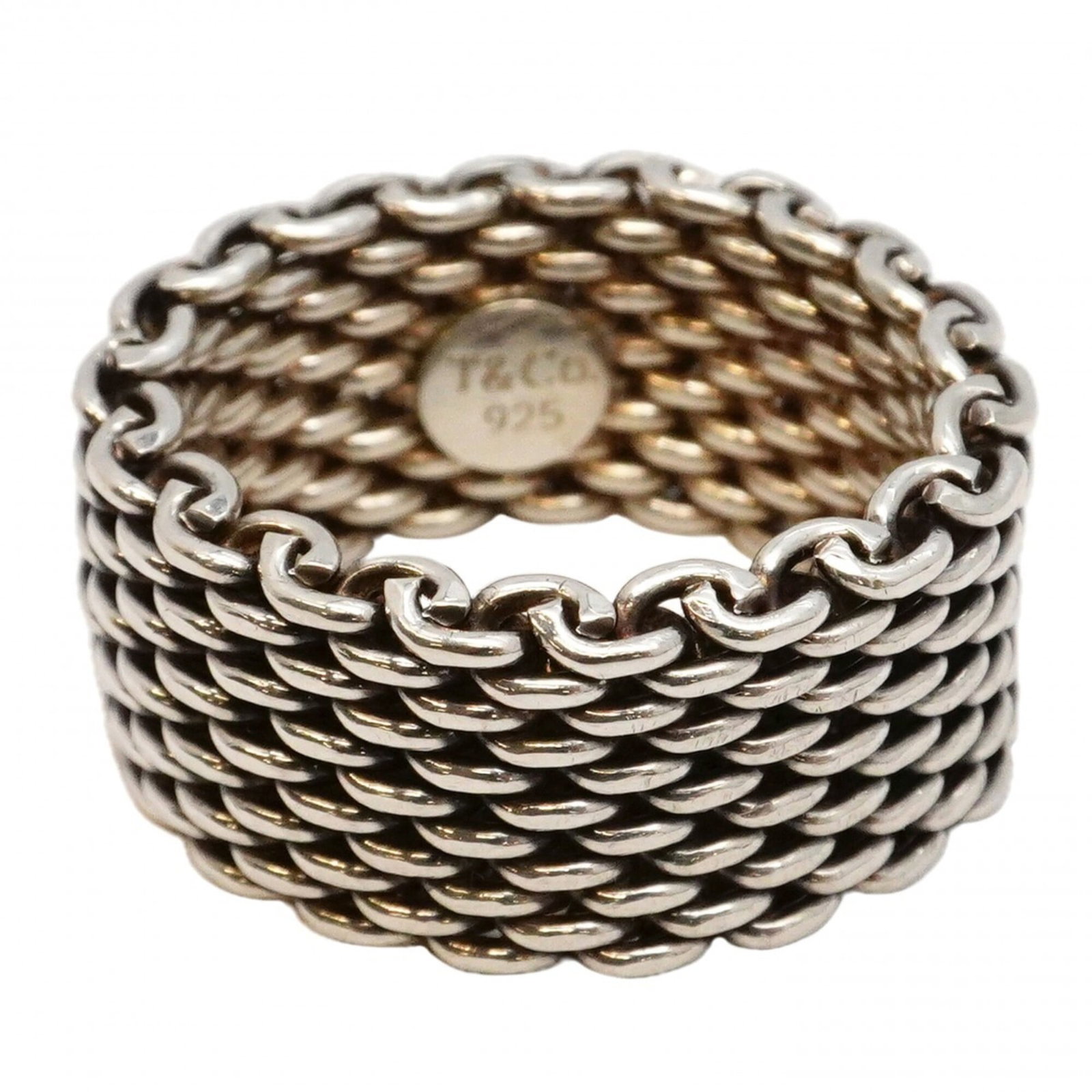 Tiffany Band Ring Silver 925: Tiffany Band Ring Silver 925 Silver 925 Tiffany band ring with a classic design. The ring features a subtle shine and slight scratches from previous wear, giving it a well-loved appearance. In good co