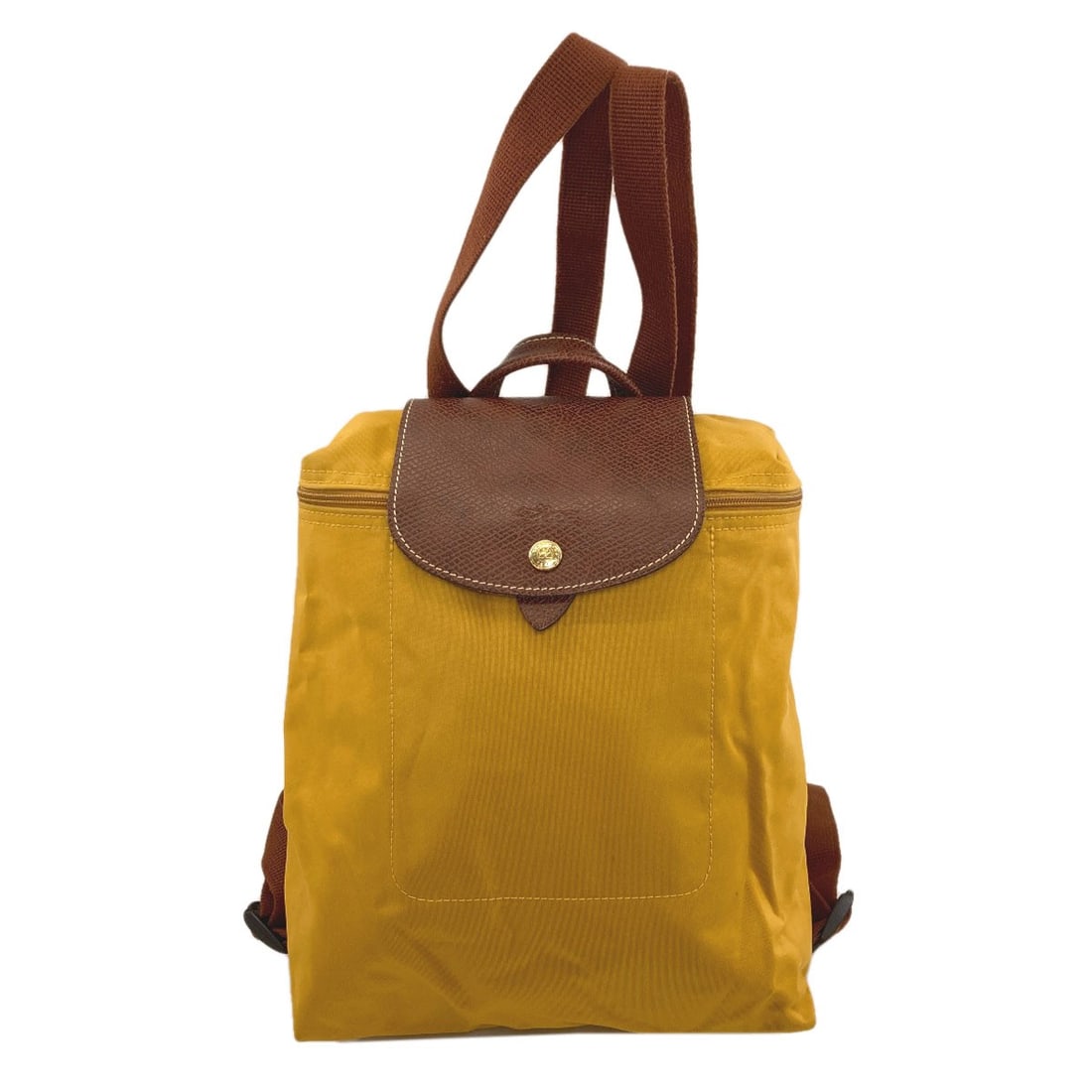 Nylon Longchamp Backpack Pliage Daypack: Nylon Longchamp Backpack Pliage Daypack Yellow Nylon Longchamp Backpack Pliage Daypack. Made from durable nylon, this backpack features a classic design with a bright yellow exterior. The Pliage style