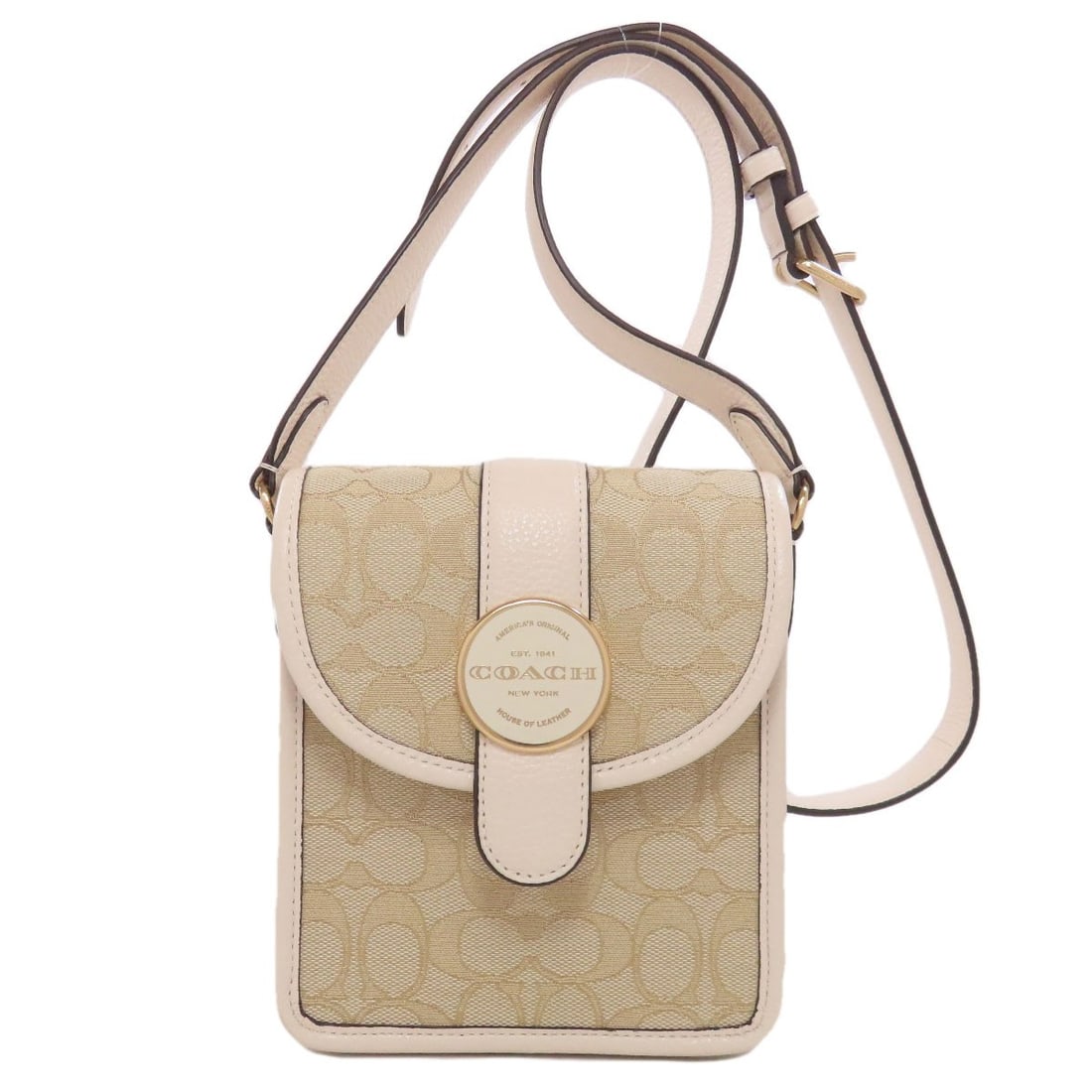 Coach C8321 Cross Ronnie North South Bag Canvas: Coach C8321 Cross Ronnie North South Bag Canvas Canvas shoulder bag with beige and white exterior. Features a classic design with a canvas material, making it a timeless accessory for everyday use. Th