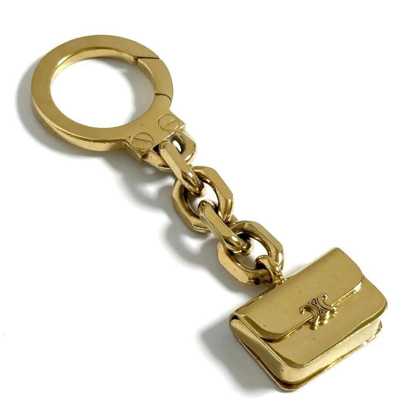 Celine Keyring Metal: Celine Keyring Metal This Celine Keyring Metal is a stylish accessory with a sleek metal design. Made from durable material, its compact size makes it easy to carry and attach to any keychain. With so