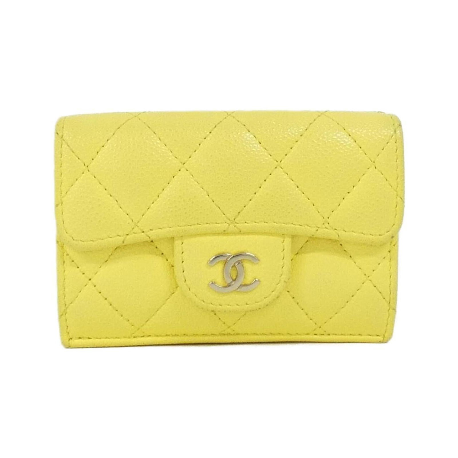 Chanel Wallet (Tri-Fold) Grained Calfskin: Chanel Wallet (Tri-Fold) Grained Calfskin This iconic Chanel tri-fold wallet boasts a classic design and premium grained calfskin construction. With its timeless yellow color, this piece exudes effort