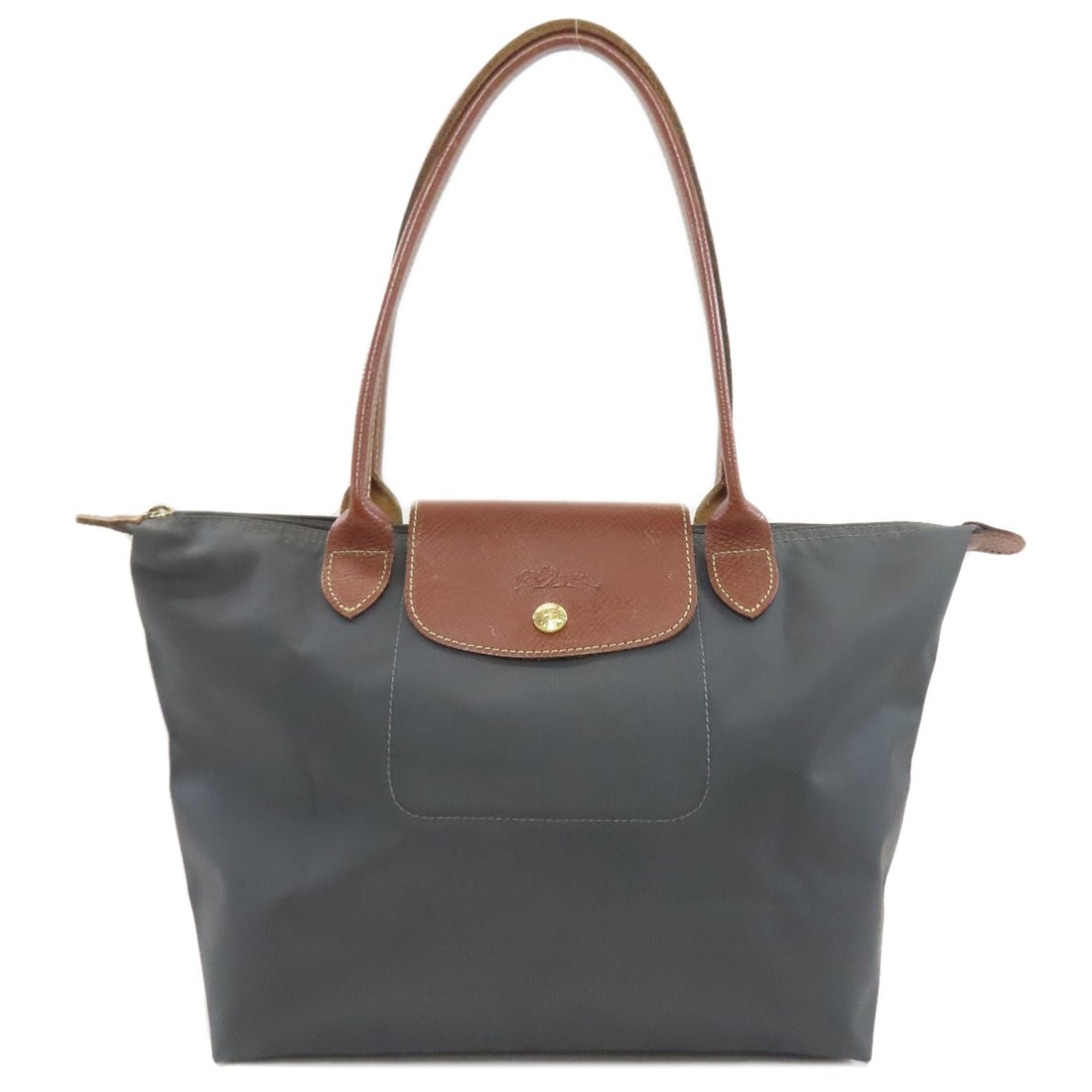Nylon tote bag from Le Pliage: Nylon tote bag from Le Pliage The Longchamp Le Pliage nylon tote bag features a durable and versatile design made from high-quality nylon. Its gray exterior provides a sleek and timeless appearance,