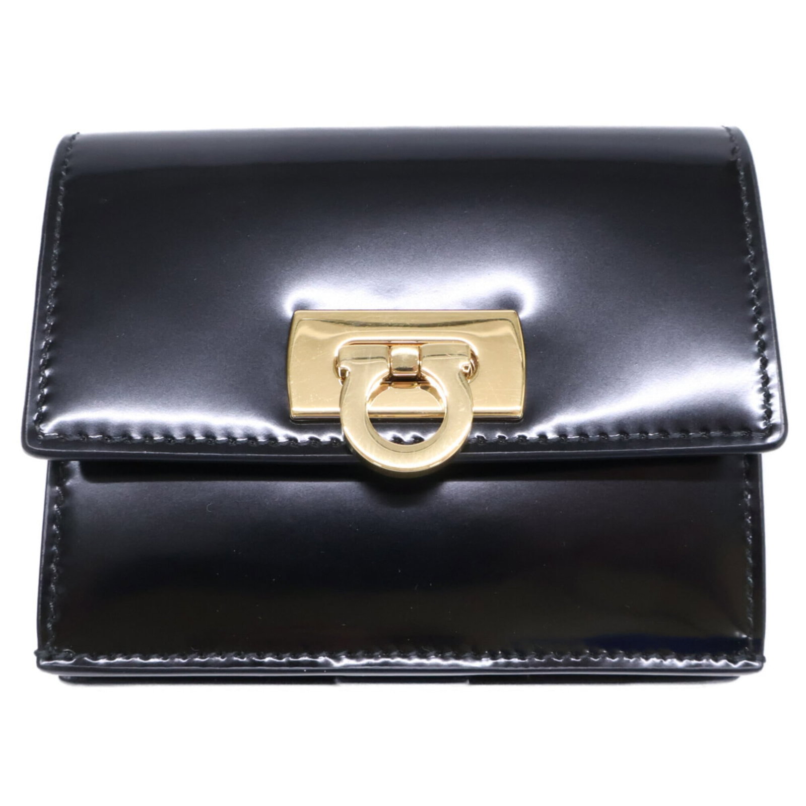 Salvatore Ferragamo Wallet (Bi-Fold) Leather: Salvatore Ferragamo Wallet (Bi-Fold) Leather This Salvatore Ferragamo bi-fold leather wallet features sleek black and gold accents. Made from high-quality leather, its classic design exudes timeless