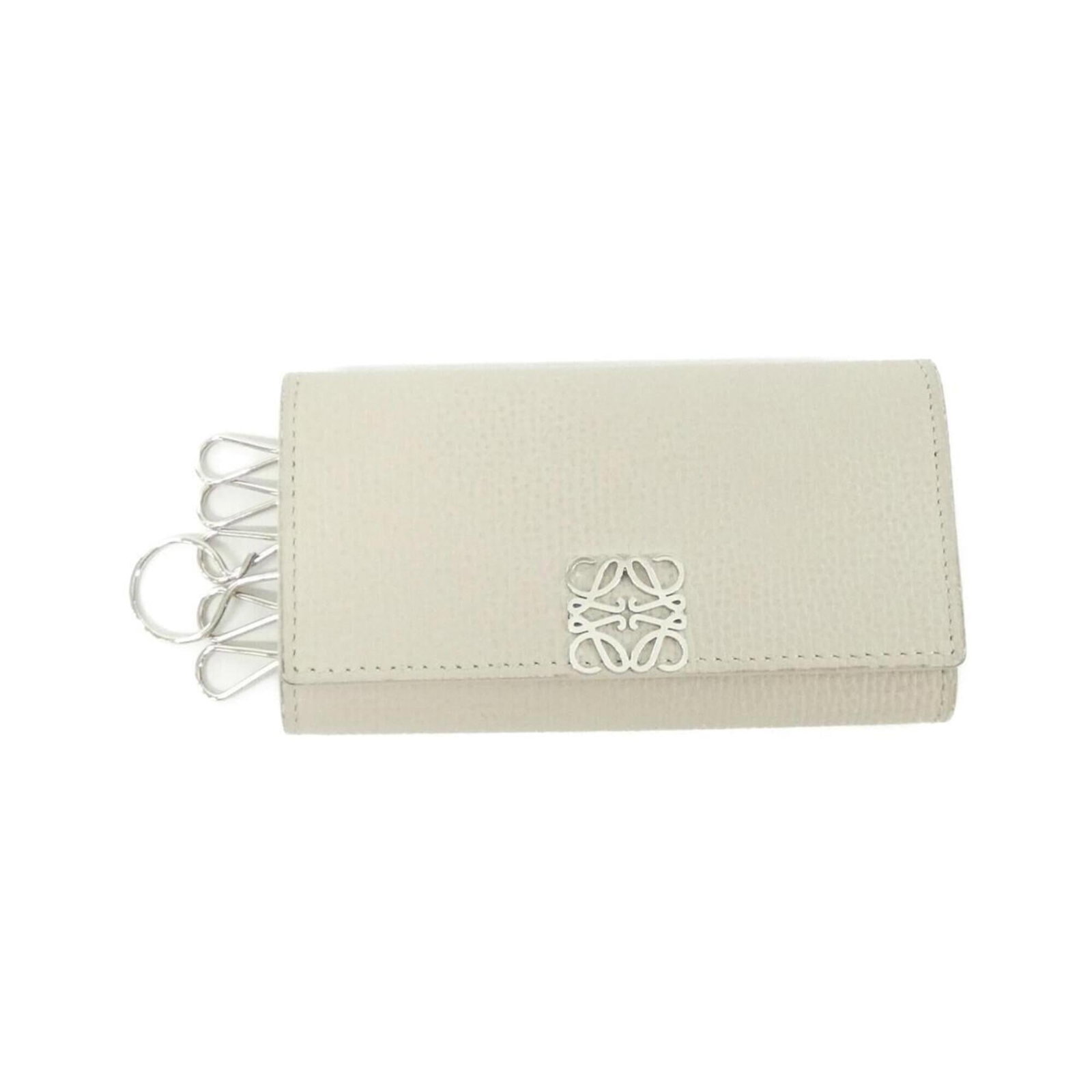 Loewe Keycase Leather: Loewe Keycase Leather This pre-owned Loewe Keycase Leather features high-quality calfskin construction and a classic design. The leather has developed a few traces of usage, with some scratches and di