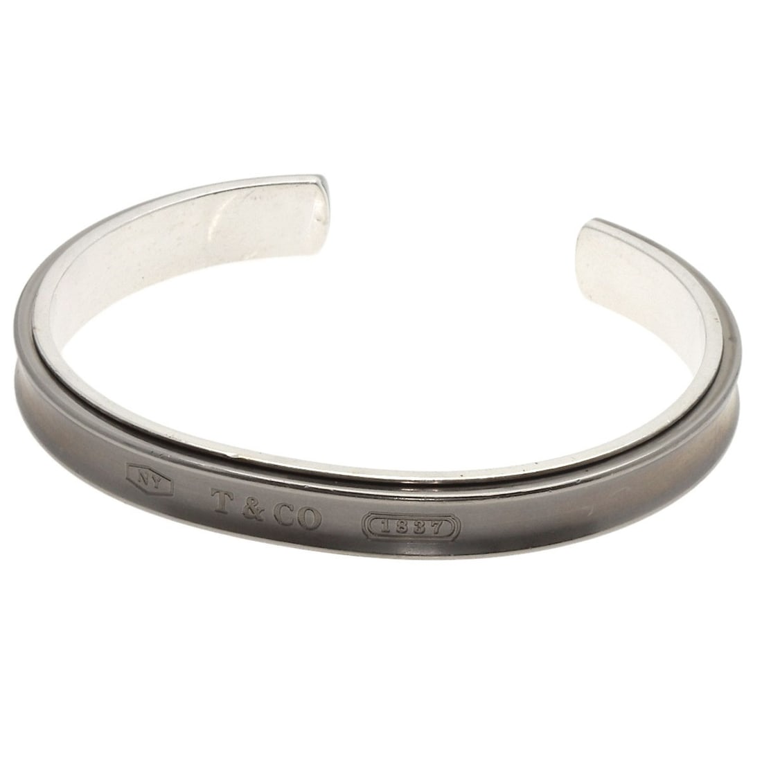 Tiffany and Co 1837 Silvery Titanium Bracelet: Tiffany and Co 1837 Silvery Titanium Bracelet The Tiffany and Co 1837 Silvery Titanium Bracelet boasts a sleek silver finish and durable titanium construction. This stylish bracelet features no main