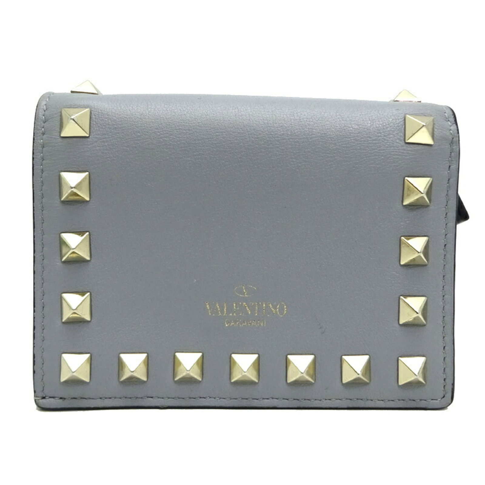 Valentino Garavani Wallet (Bi-Fold) Leather: Valentino Garavani Wallet (Bi-Fold) Leather The Valentino Garavani bi-fold wallet boasts sleek gray leather and a classic snap fastener closure. With its compact size and timeless design, this versati