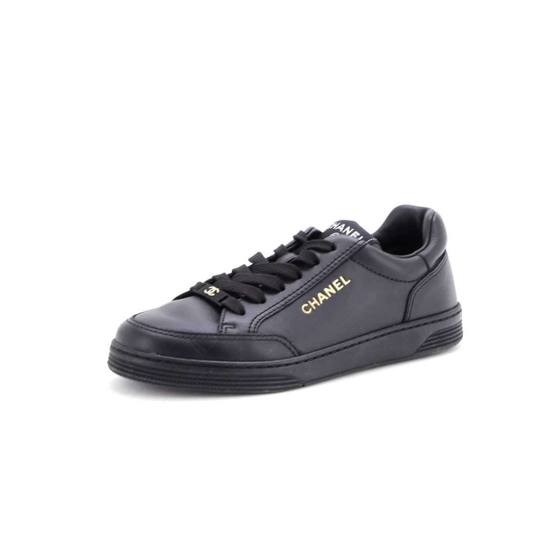 Chanel Low Top Leather Sneakers: Chanel Low Top Leather Sneakers Black leather low-top sneakers with gold hardware from Chanel. Featuring a classic design and premium materials, these shoes showcase a stylish and timeless look. With 