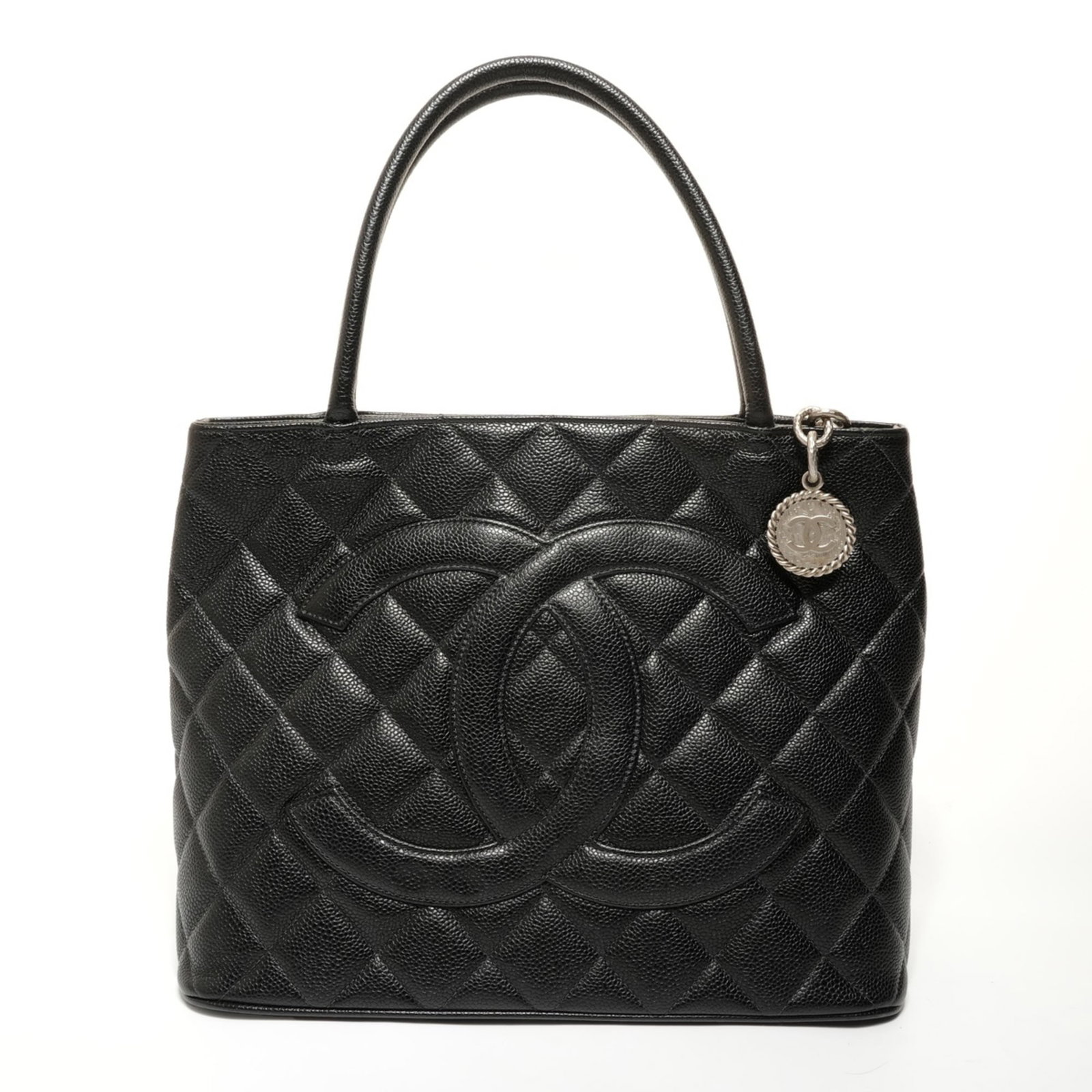 Chanel Tote Bag Grained Calfskin: Chanel Tote Bag Grained Calfskin The Chanel Tote Bag Grained Calfskin features a classic design with a timeless black color and high-quality grain calfskin material. Its spacious interior and adjustab