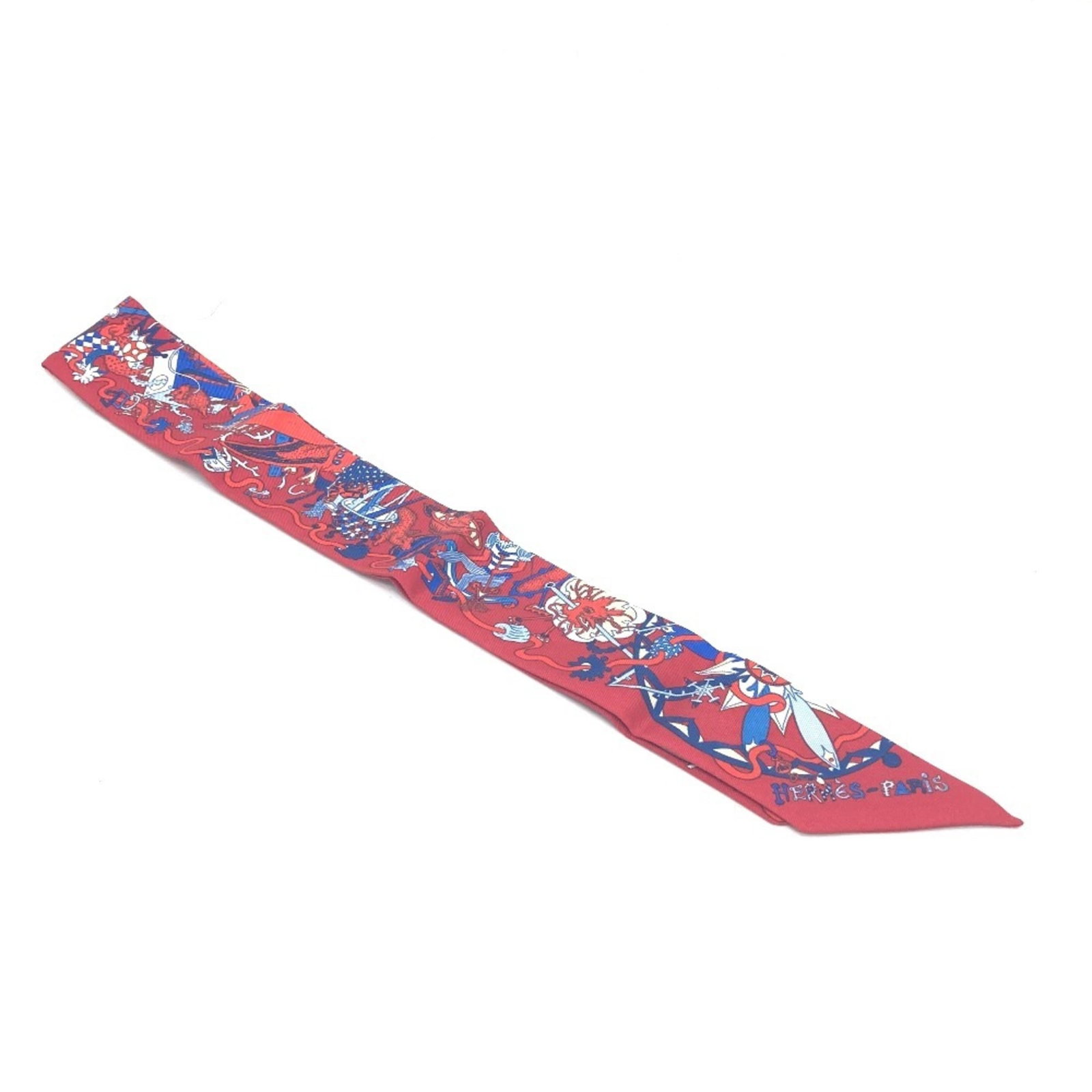 Hermes Scarf Silk: Hermes Scarf Silk Red silk scarf from Hermes featuring a casual design. The scarf has been used and shows traces of usage with minor scratches and dirt, but remains in good condition overall. Its