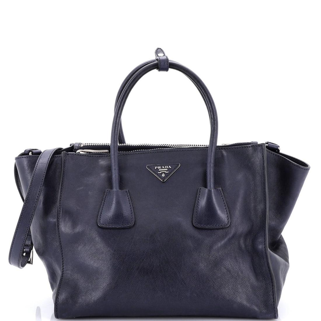 Twin Pocket Convertible Leather Tote Medium Prada: Twin Pocket Convertible Leather Tote Medium Prada Twin pocket convertible tote in blue leather with silver hardware. This medium-sized tote features two spacious pockets and an adjustable strap for
