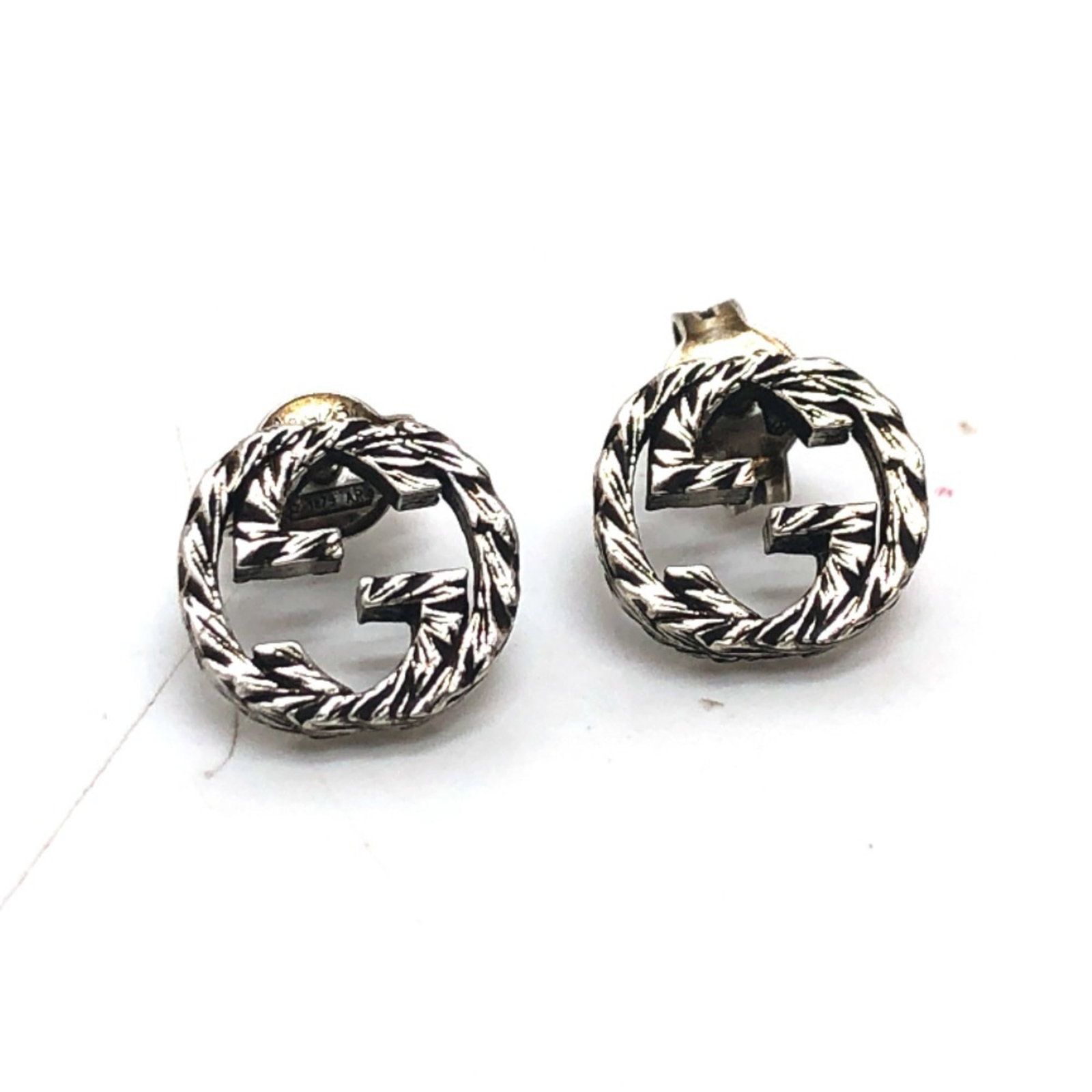 Gucci Stud Earrings Silver 925: Gucci Stud Earrings Silver 925 Silver 925 Gucci Stud Earrings with a sleek design and subtle shine. Traces of usage are visible, including scratches and dirt, giving them a worn-in look. These earring