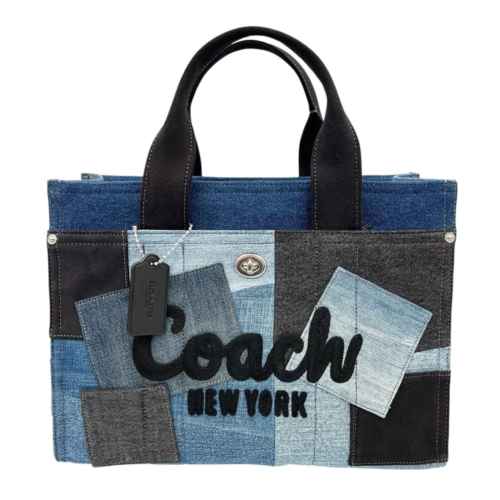 Coach Handbag Denim: Coach Handbag Denim Coach Handbag Denim - A unique and stylish blue denim handbag from Coach. This opened, never-used bag features a distinctive denim material and measures 25.5cm x 34cm x 16cm. Its c