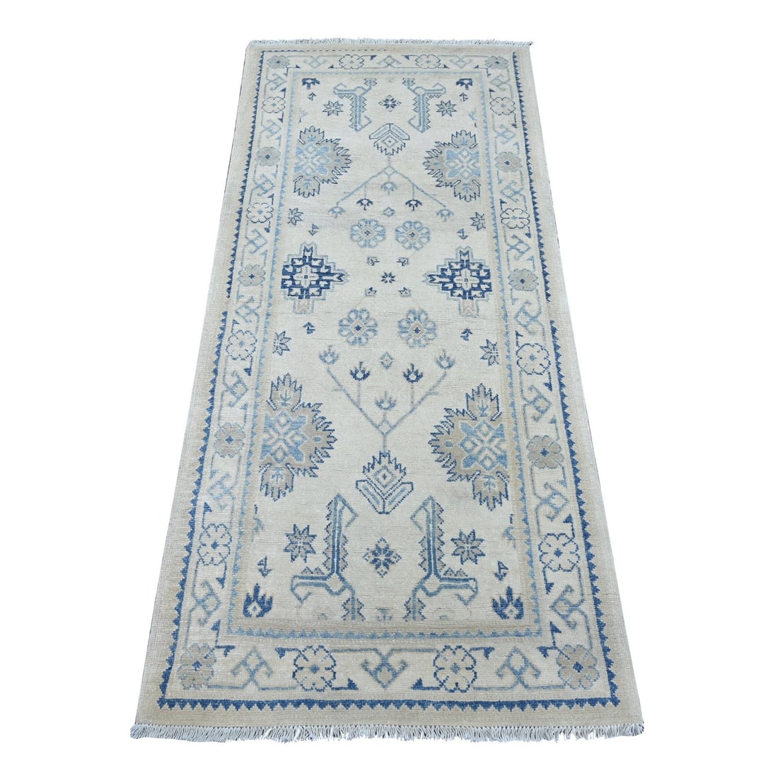 Ivory vintage look kazak all over hand knotted wool runner: Ivory vintage look kazak all over hand knotted wool runner Hand-knotted wool in an all-over ivory design creates a stunning visual effect on this vintage kazak-style runner. Measuring 2'7" x 5'9",