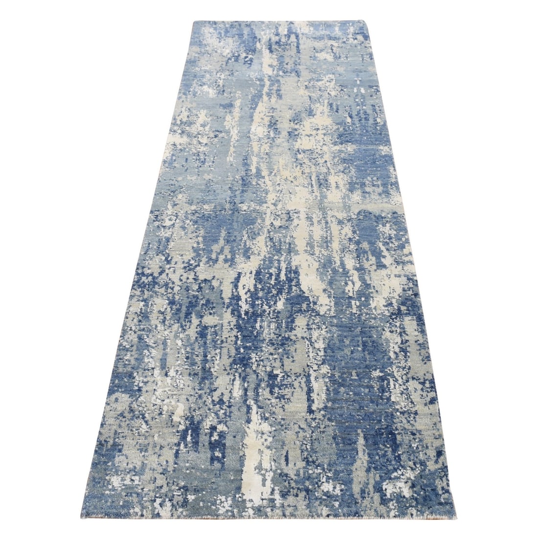 Blue wool silk hand knotted abstract rug: Blue wool silk hand knotted abstract rug Blue wool silk hand knotted abstract rug features an Oriental regional design in shades of blue, gray, and ivory on a cotton foundation. Hand-knotted with wool